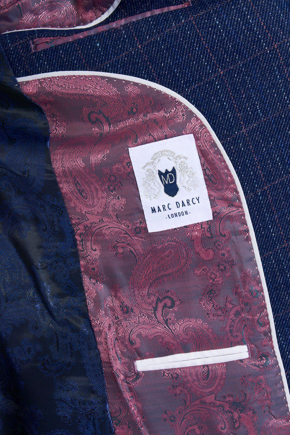 Close-up of the HARRY - Indigo Tweed Check Blazer’s inner lining, featuring blush pink and blue paisley patterns, a white pocket, and a white marcdarcy label—ideal for sophisticated wedding attire.