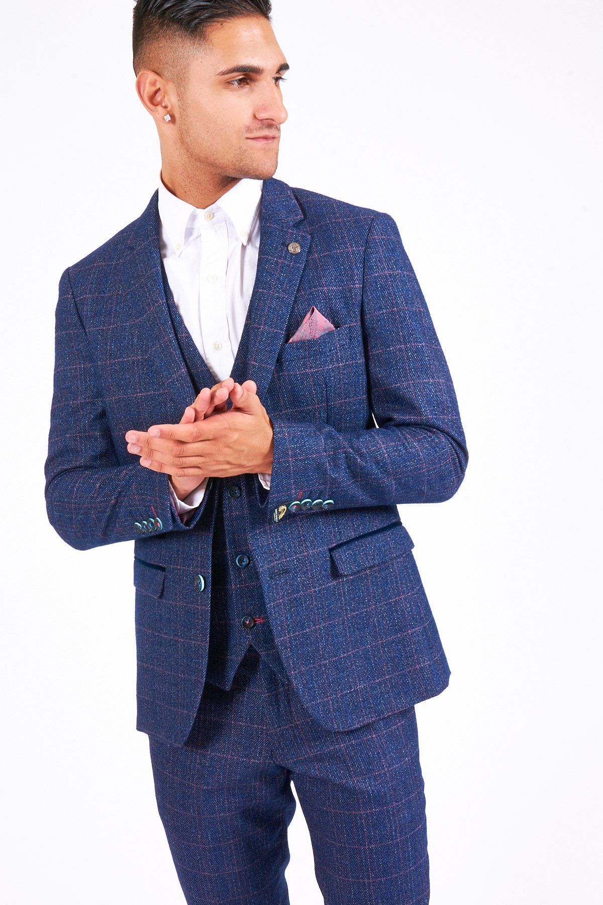 A man models the marcdarcy HARRY Indigo Tweed Check Blazer with a white shirt and blush pink pocket square against a white background—chic inspiration for modern wedding style.