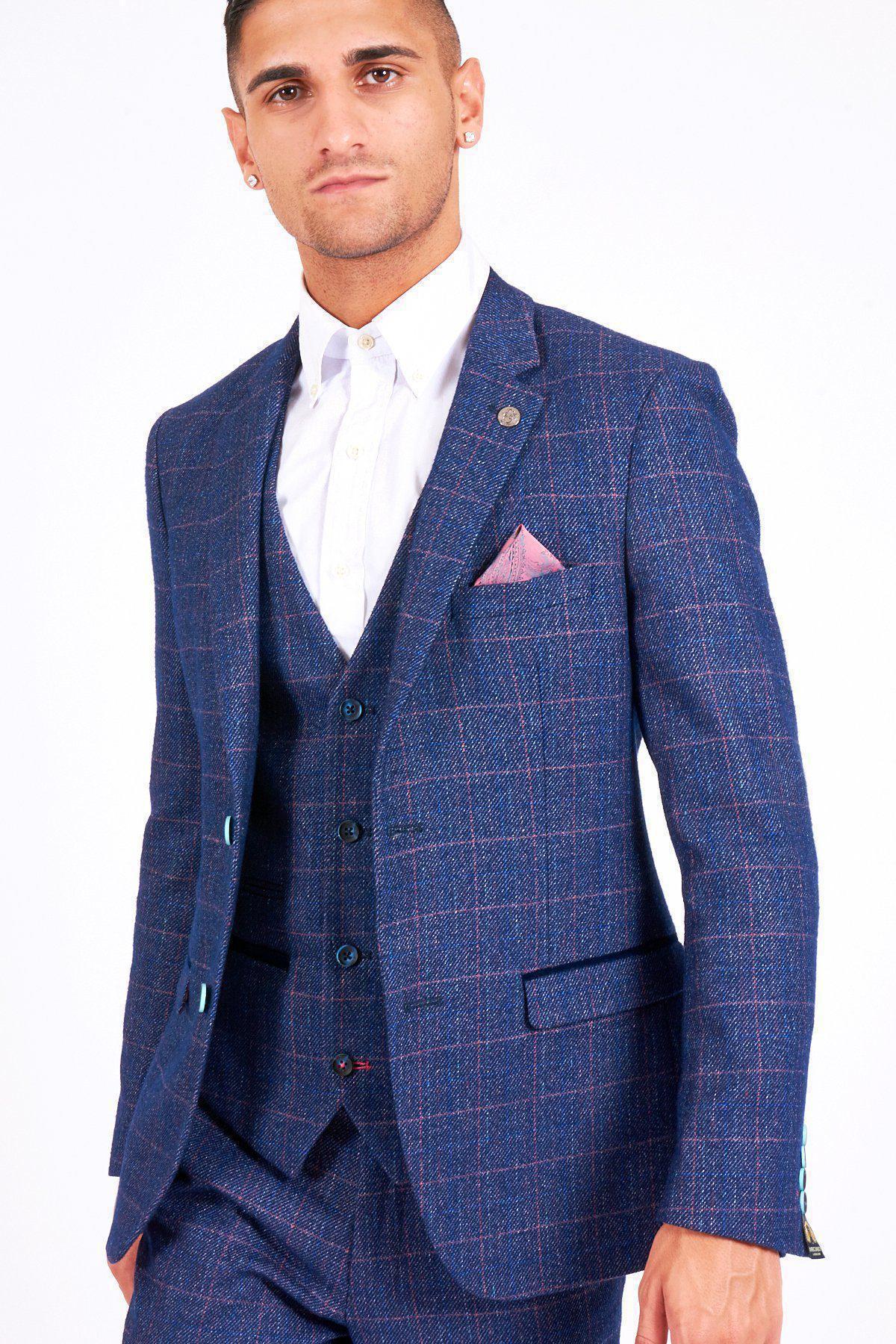 A person models the marcdarcy HARRY Indigo Tweed Check Blazer with a white dress shirt and blush pink pocket square, set against a plain white background—ideal for stylish wedding attire.