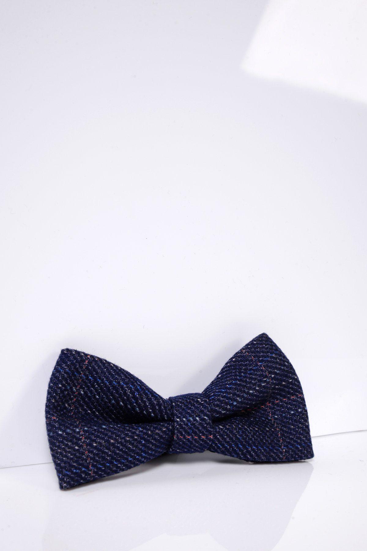 The HARRY – Indigo Tweed Check Bow Tie by Accessory, featuring a dark blue check pattern and adjustable band, is displayed on a glossy white surface with a white background.