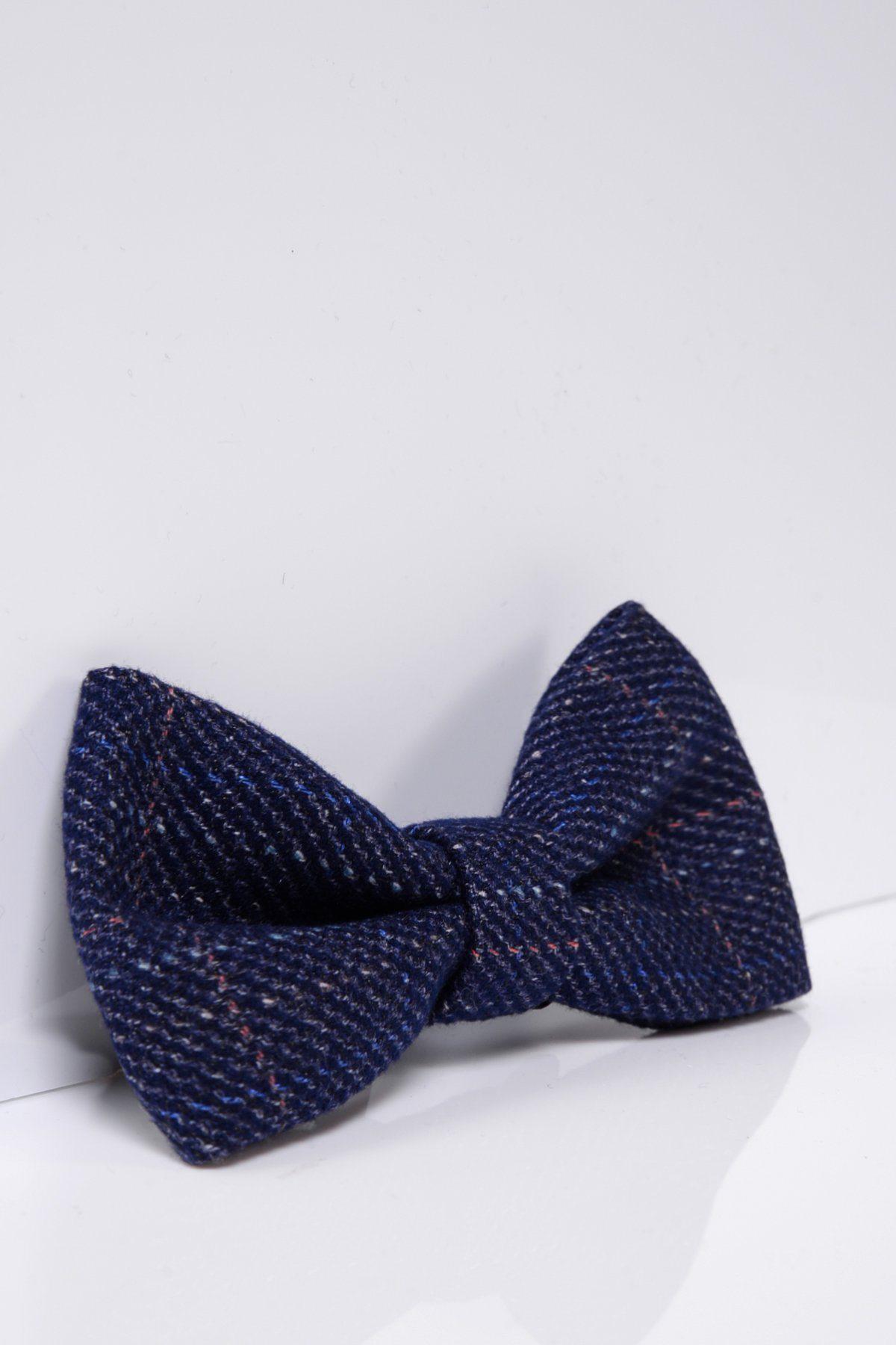 The HARRY – Indigo Tweed Check Bow Tie by Accessory, featuring subtle light and reddish checks and an adjustable band, is displayed against a plain white background.