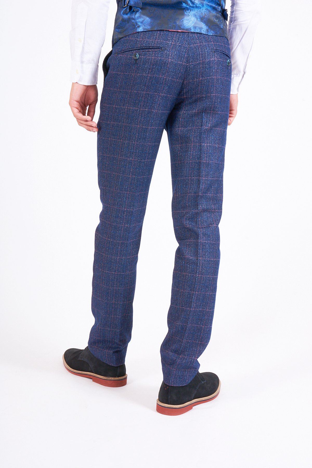 Man in marcdarcy's HARRY Indigo Tweed Check Trousers, white shirt, blue patterned vest, and black shoes with red soles—an ideal wedding look.