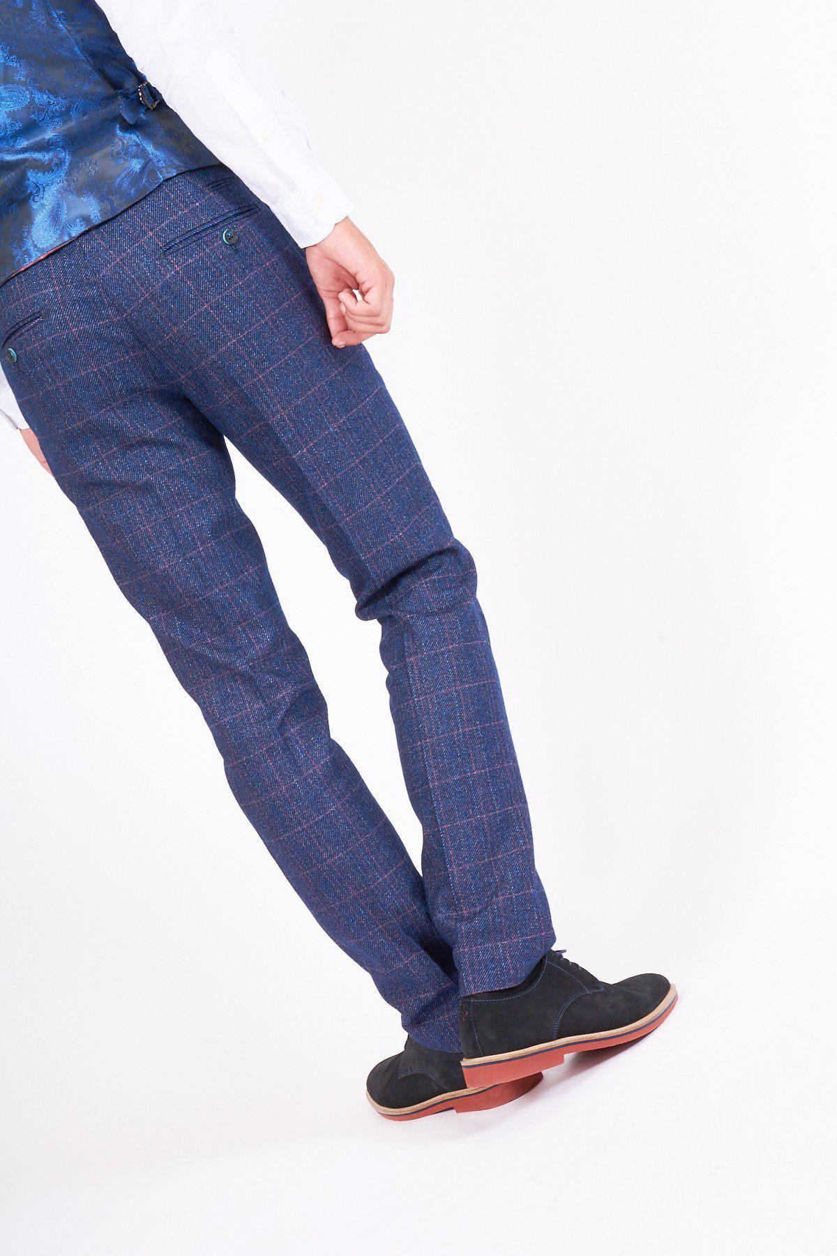 A person wears marcdarcys HARRY Indigo Tweed Check Trousers with a white shirt, blue patterned vest, and black dress shoes, standing against a white background for an effortlessly polished wedding look.