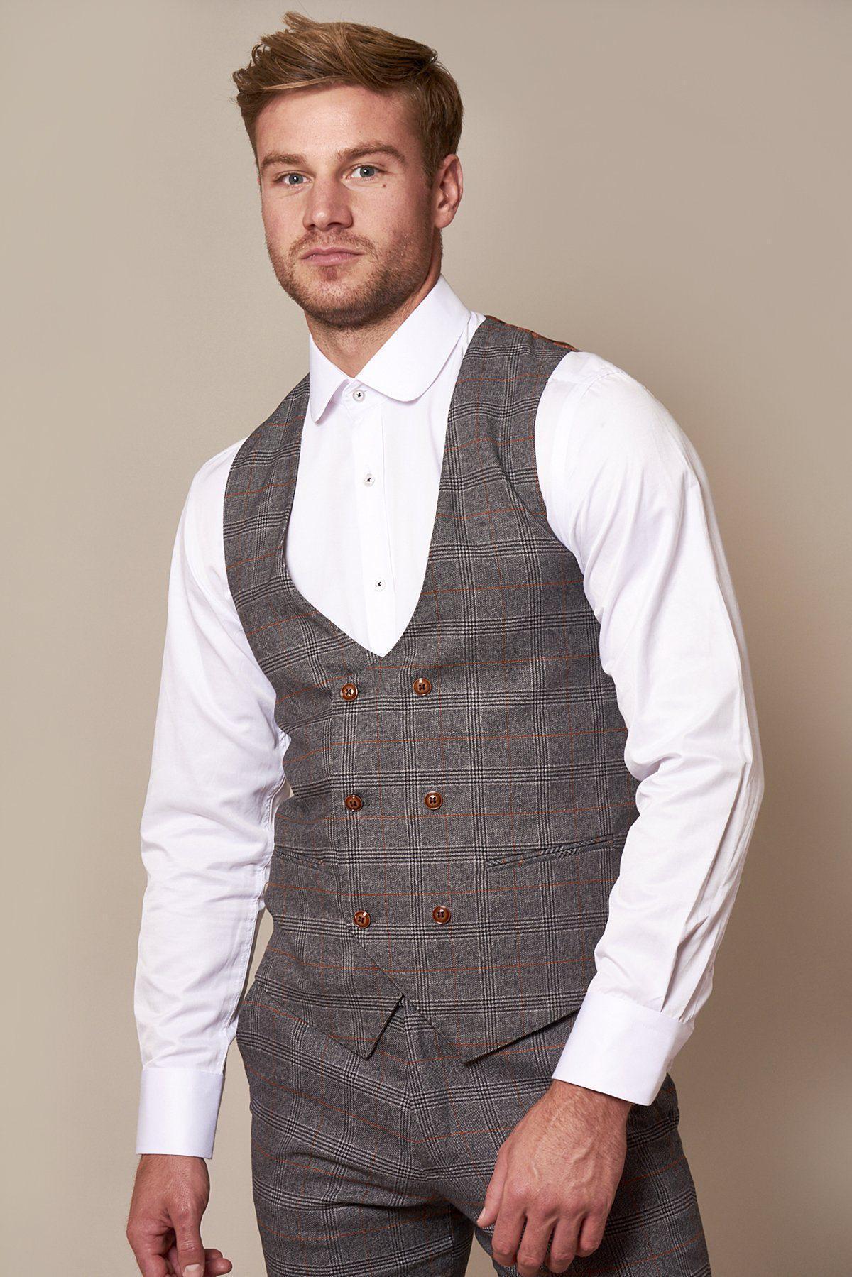 A man wears marcdarcy’s Sheffield Utd Collection: the Billy Sharp in Jenson Grey Check Suit, featuring a slim tailored fit and bold grey and orange plaid for a sharp men's look.
