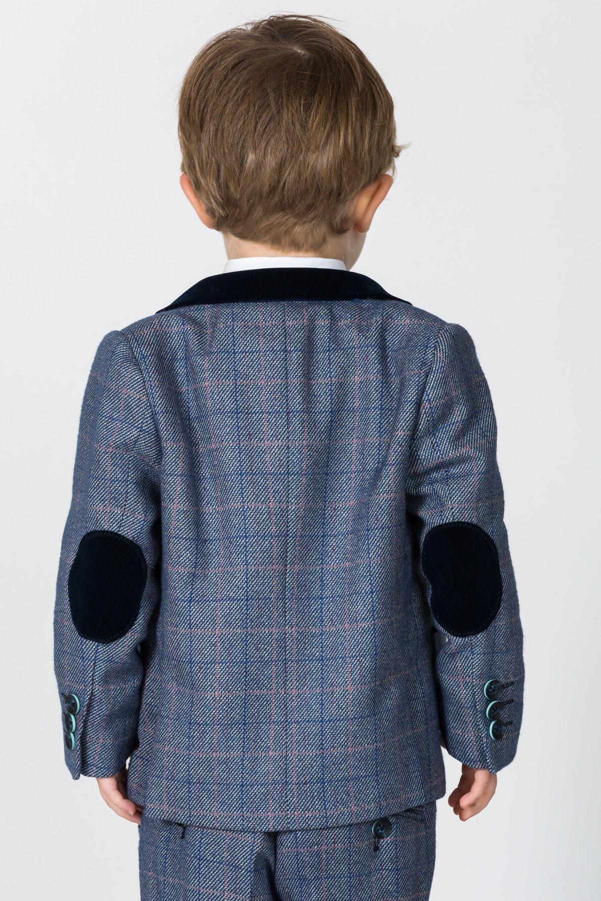 Back view of a boy in the marcdarcy HILTON Children's Blue Tweed Check Three Piece Suit featuring navy velvet elbow patches, teal buttons, and a velvet collar over a white shirt—ideal as a boys tweed suit or ring bearer outfit.