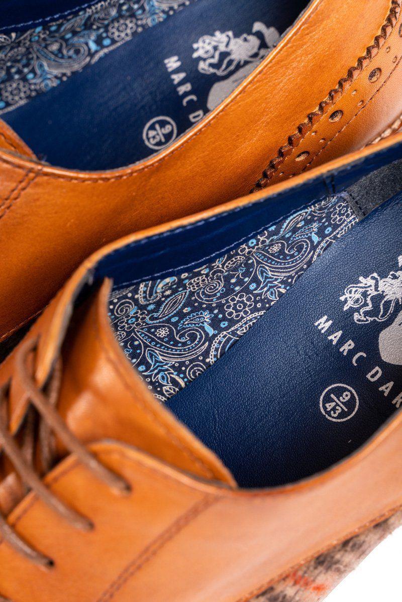 Close-up of two tan full grain leather JACOB - Tan Leather Tweed Contrast Brogue Shoes by Marc Darcy, size 43. Blue insoles feature white and blue paisley patterns—ideal for stylish grooms. Jacob shoe is visible on the insole.