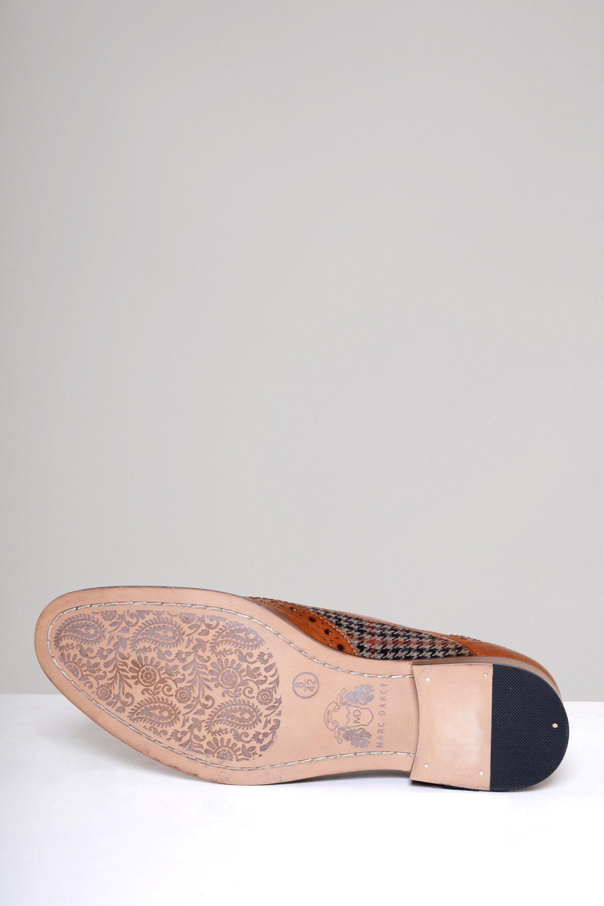 A Marc Darcy JACOB Tan Leather Tweed Contrast Brogue Shoe rests on its side, revealing a sole with an intricate floral pattern etched into light-colored full grain leather, set against a plain light gray background.