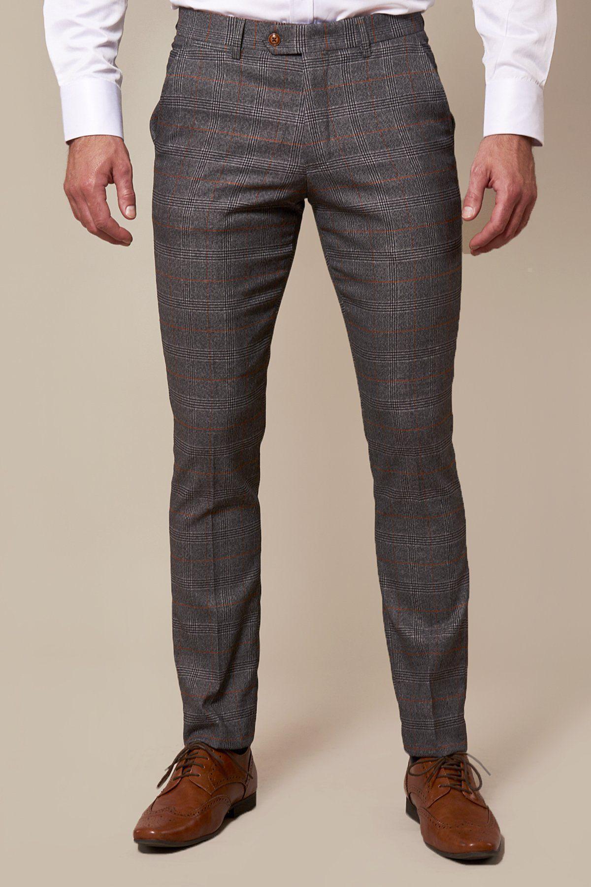 Man wearing marcdarcy JENSON Skinny Fit Grey Check Trousers with orange accents and brown wingtip shoes, evoking classic Peaky Blinders style.