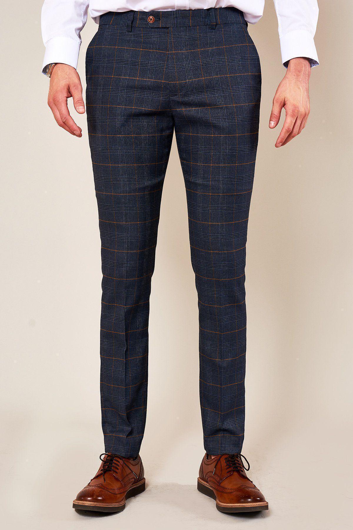 A man wears marcdarcy JENSON Skinny Fit Marine Navy Check Trousers, a white dress shirt, and brown dress shoes. His hands rest relaxed at his sides against a plain background.