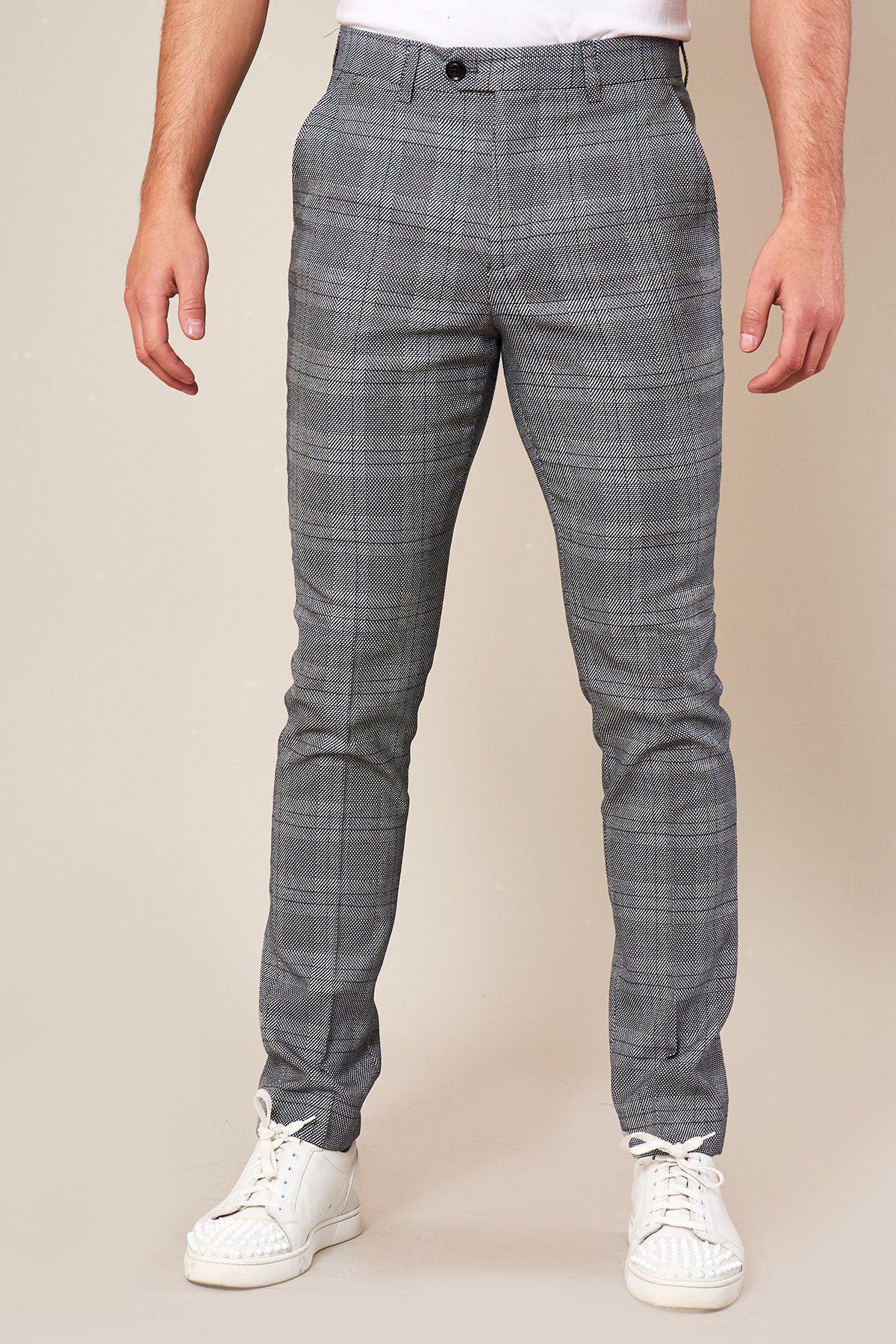 A person wearing marcdarcys JERRY Skinny Fit Grey Check Trousers and white sneakers stands against a plain light background, with their upper body not fully visible.