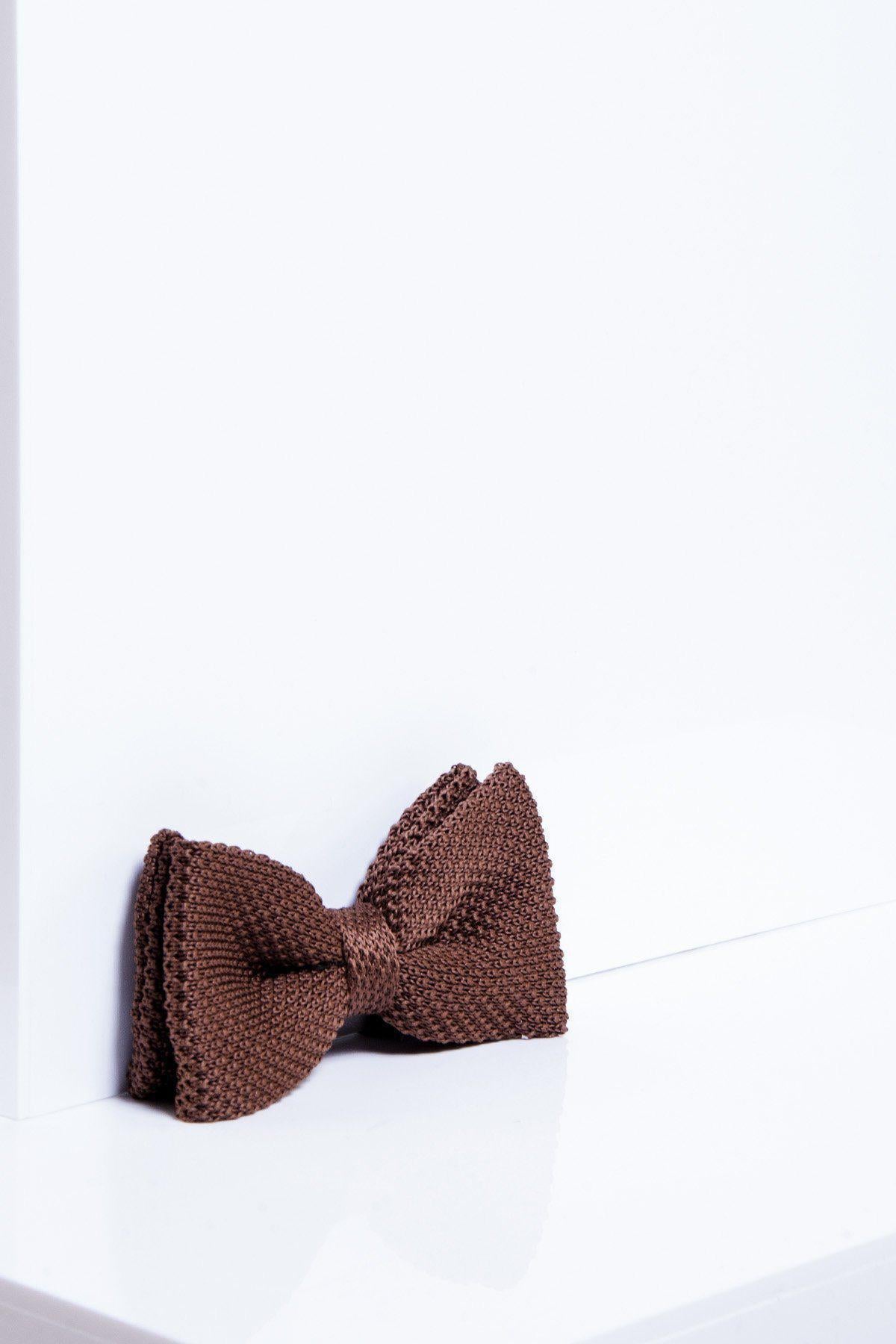 The marcdarcy KB - Knitted Double Layer Bow Tie In Tan stands upright against a white backdrop, its rich color and textured knit perfectly showcased by the minimal setting—an ideal stylish accessory for autumn and winter.