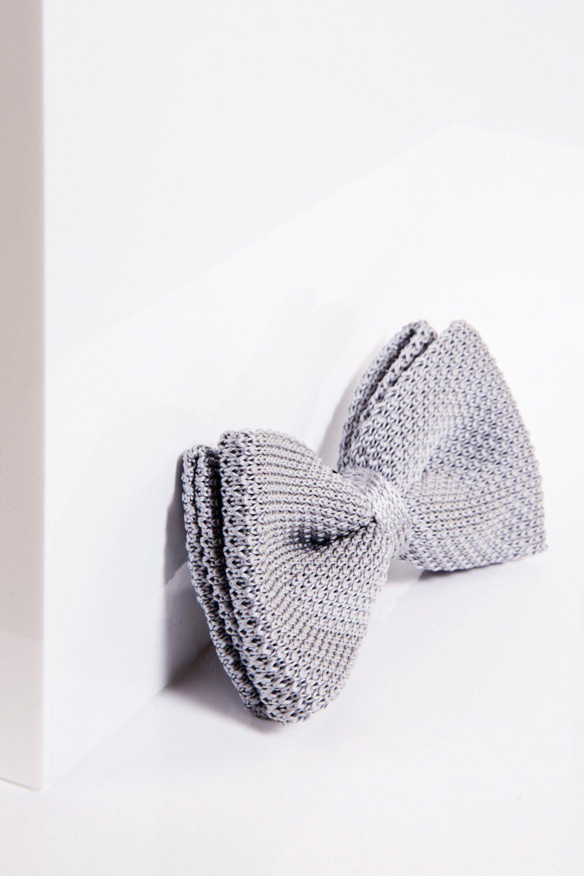The marcdarcy KB - Knitted Double Layer Bow Tie in Silver Grey is displayed on a white surface, with soft lighting casting gentle shadows.
