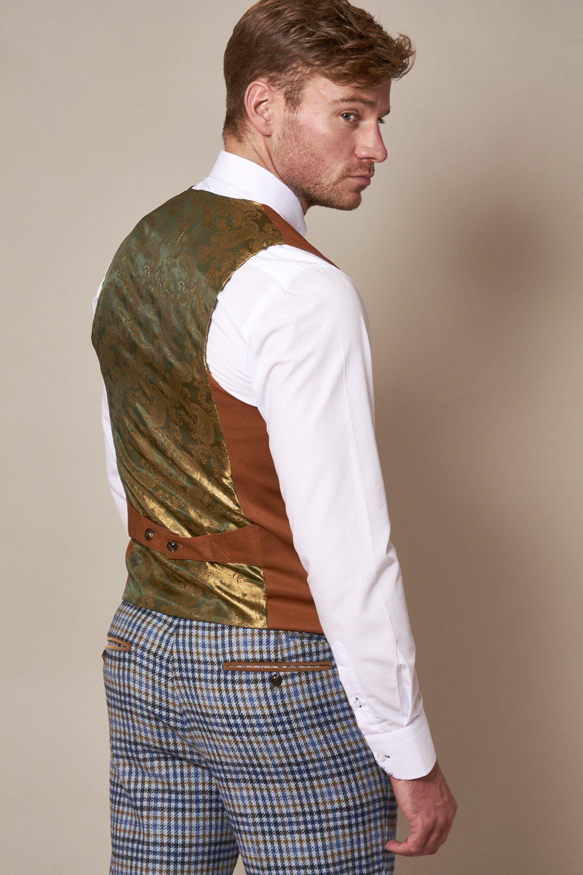 Back view of a man wearing the marcdarcy KELLY dark tan double-breasted waistcoat with green and gold paisley lining, paired with a white dress shirt and blue checked trousers.