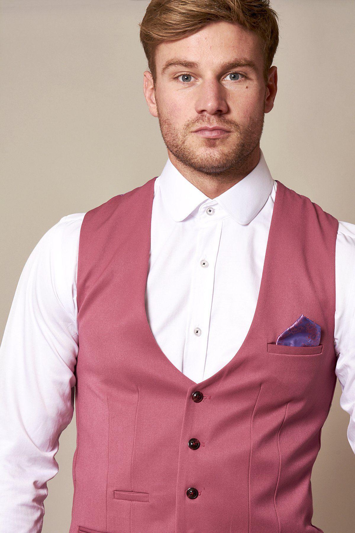 A man with short light brown hair wears a white dress shirt and the marcdarcy KELLY Pink Single Breasted Waistcoat with a purple pocket square, posing against a neutral background.