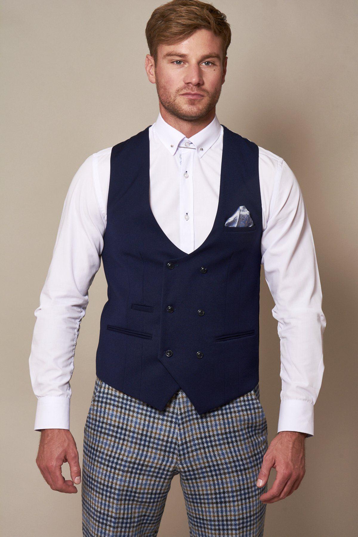 A man wears the marcdarcy KELLY Royal Blue Double Breasted Waistcoat over a white dress shirt and plaid pants.