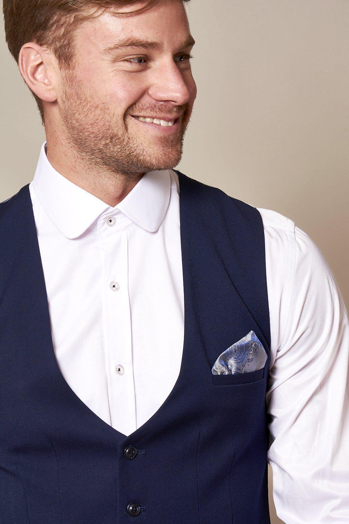 A man wears the marcdarcy KELLY Royal Blue Single Breasted Waistcoat in a slim fit over a white shirt, finished with a patterned pocket square.