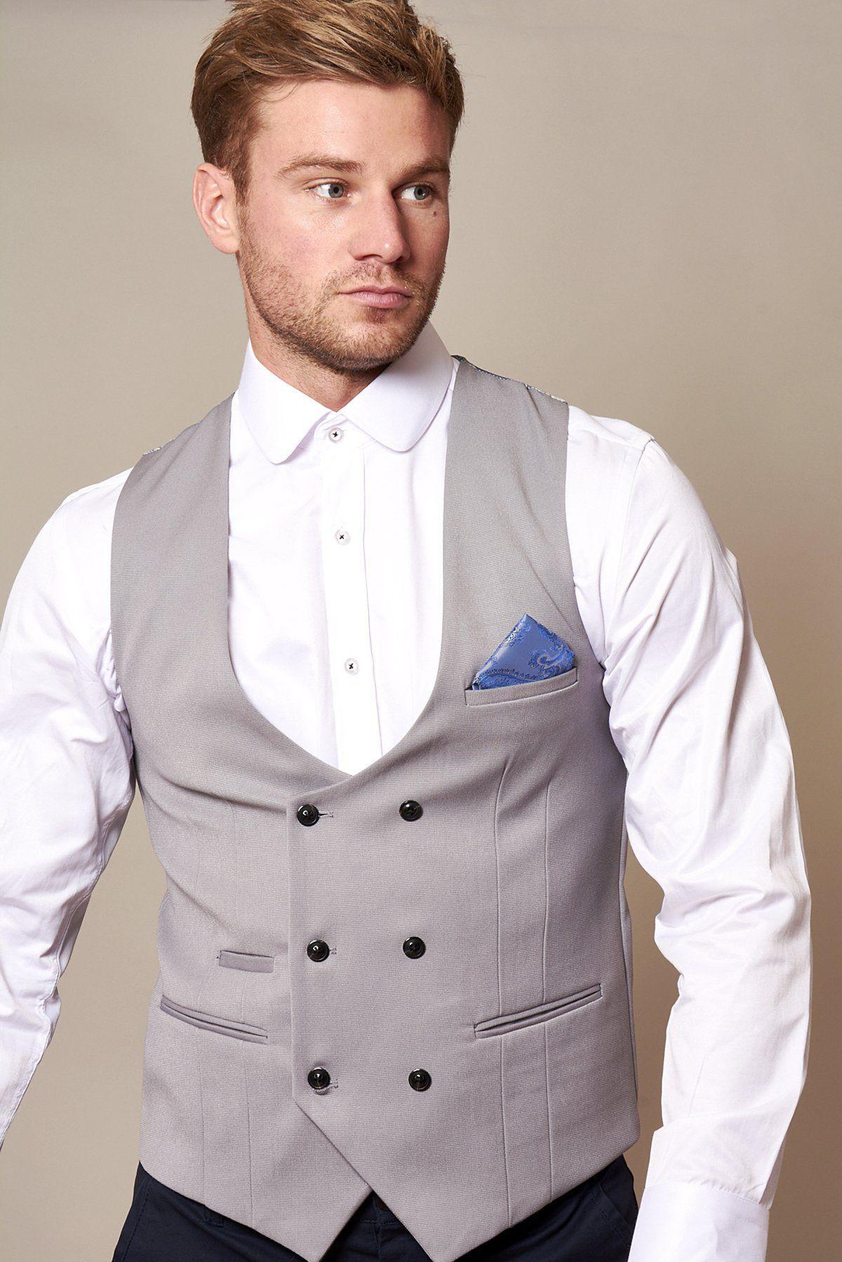 A man wearing a white shirt and the marcdarcy KELLY - Silver Grey Double Breasted Waistcoat with black buttons and a blue pocket square stands against a plain background.