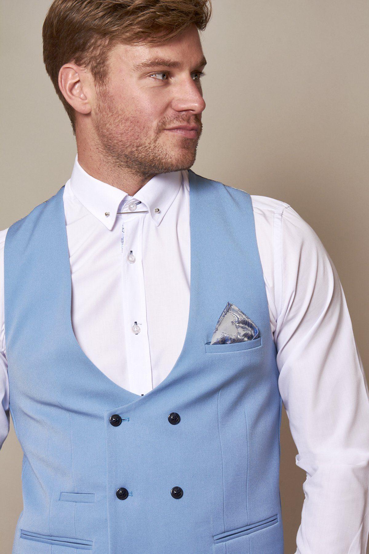 A man wearing the marcdarcy KELLY Sky Blue Double Breasted Waistcoat over a white dress shirt, styled with a patterned pocket square and light tie, looks to his left.