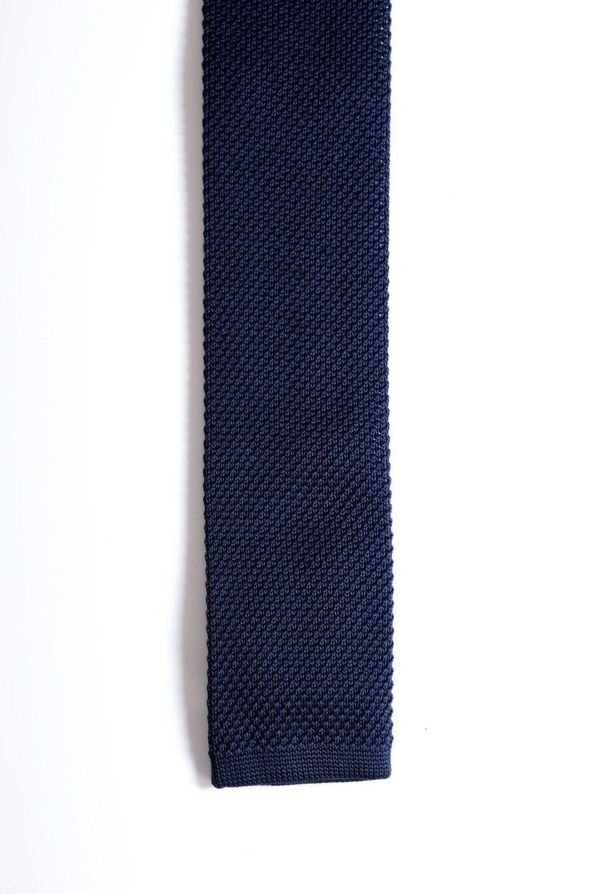The Accessory KT - Navy Knitted Tie features a textured design and flat, squared end, shown vertically against a white background.