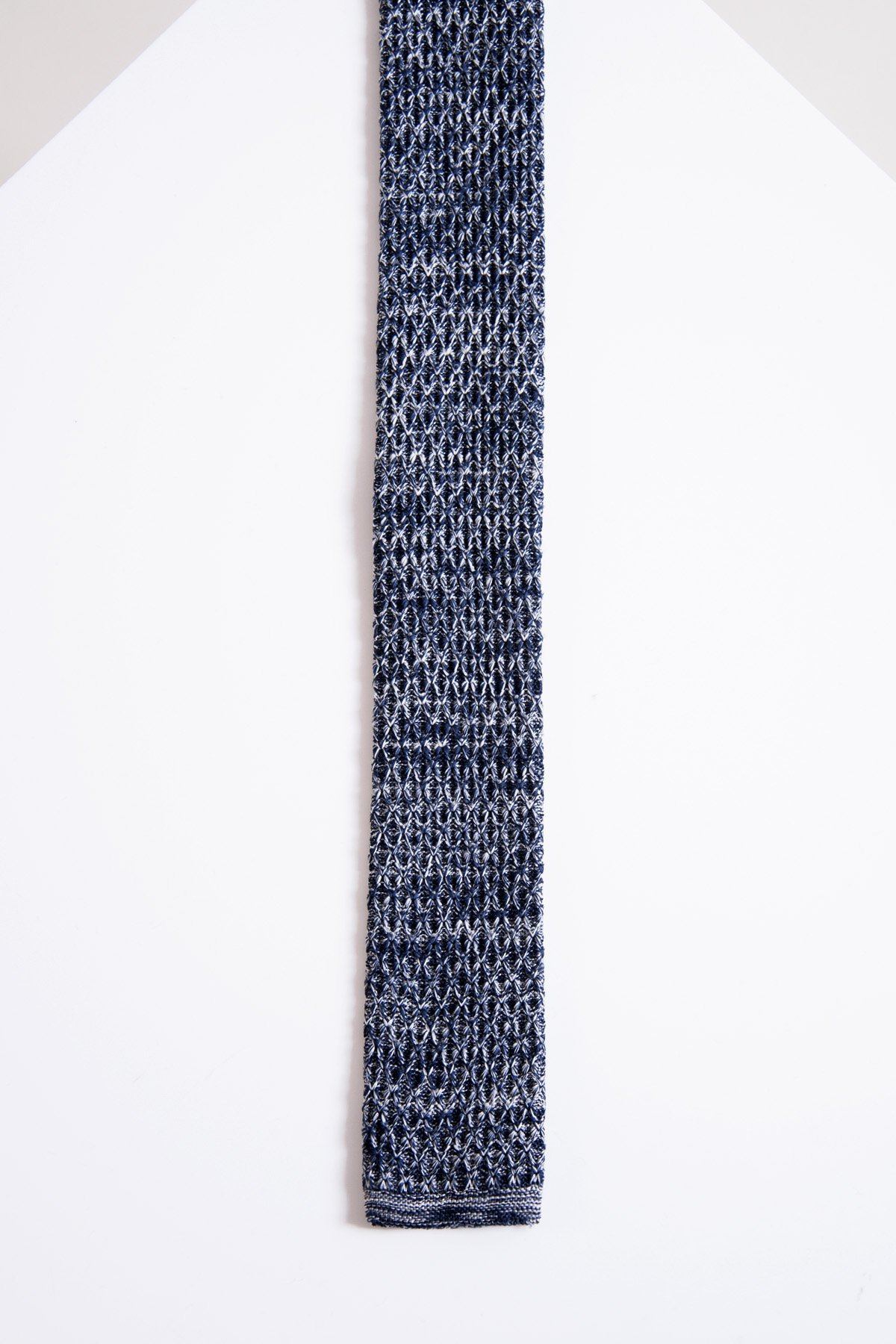 A close-up of the Accessory KT - Navy Marl Knitted Tie, featuring a contemporary textured pattern and a straight, squared end, laid flat on a white background.