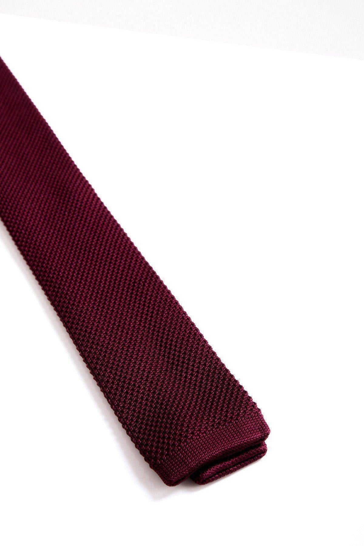 A close-up of the Accessory KT - Wine Knitted Tie, featuring a textured design on a white background—an ideal touch to elevate your wedding look.