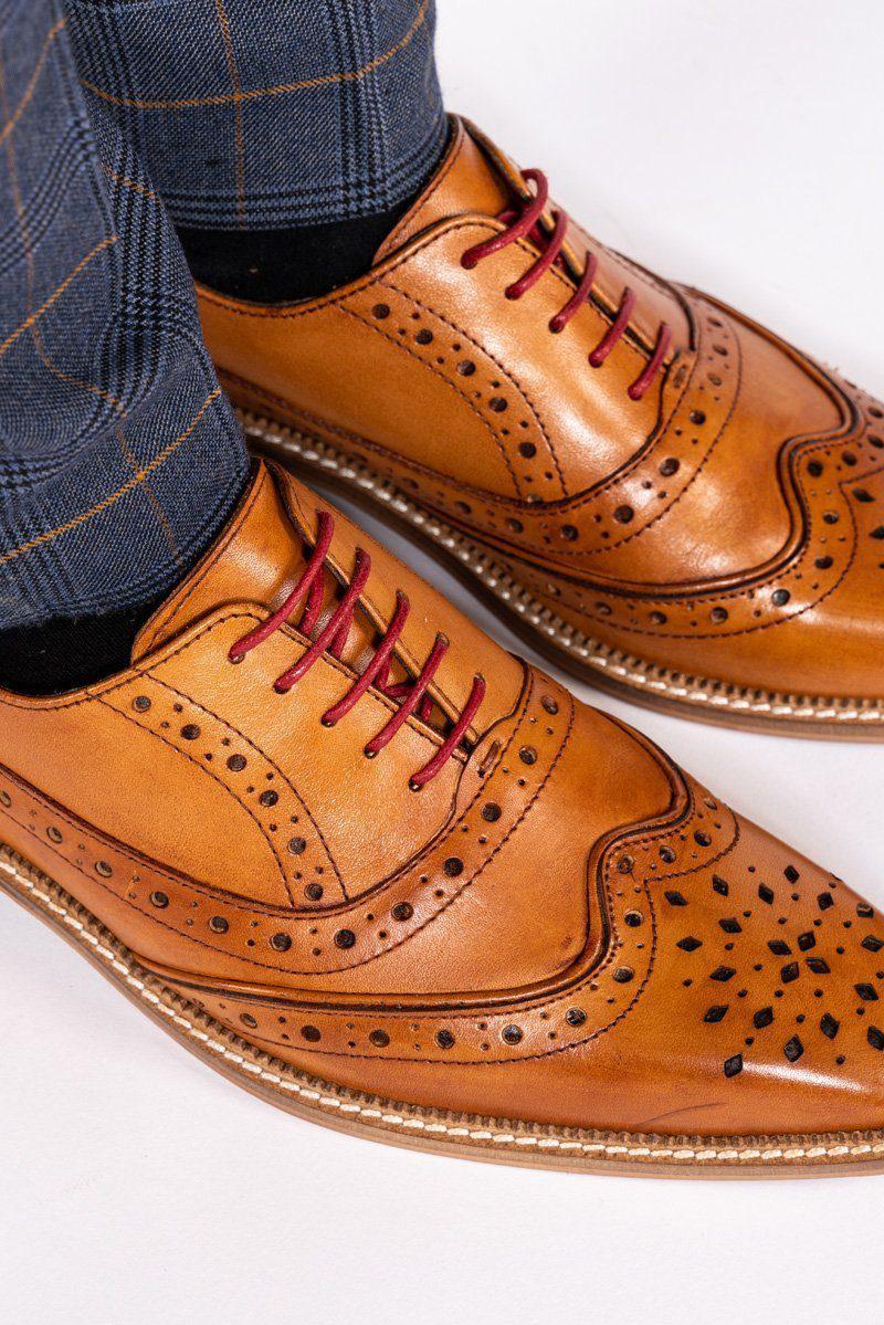A pair of Marc Darcy LARKIN mid tan leather brogue shoes paired with navy plaid pants.