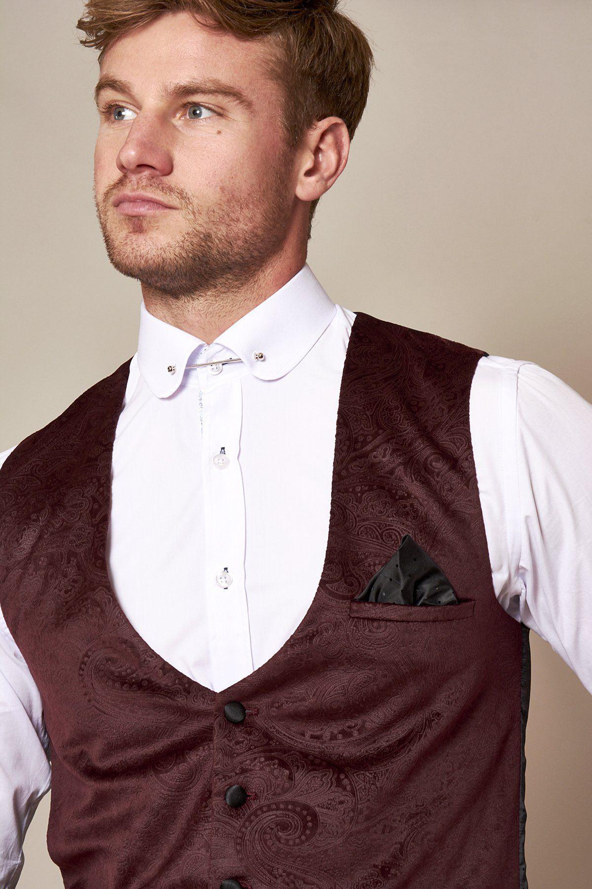 Fenerbahçe and Brazil midfielder Fred wears a Marc Darcy Simon Wine velvet suit with a decorative collar and maroon paisley vest, black buttons, and black pocket square, looking to the side against a plain background.