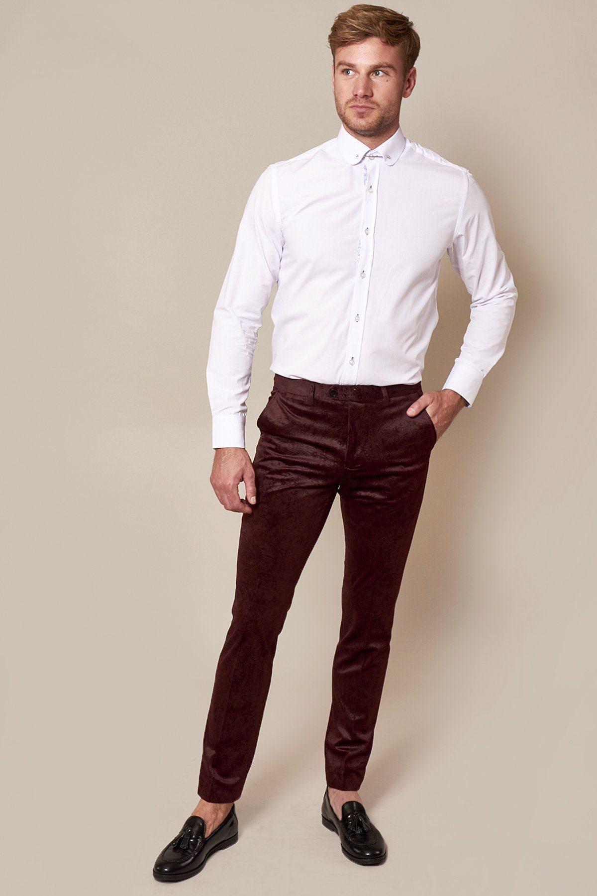 Fenerbahçe and Brazil midfielder Fred stands against a beige background wearing a Marc Darcy Simon wine velvet suit, with one hand in his pocket, looking slightly to the side.