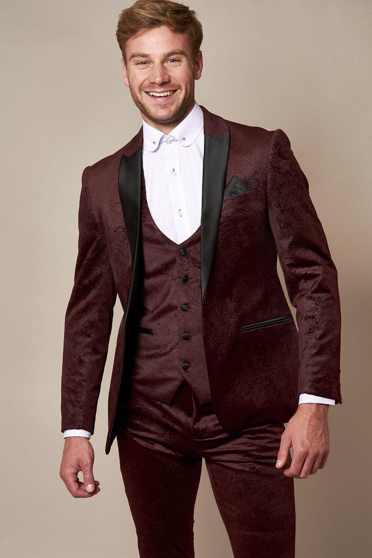 Fenerbahçe and Brazil midfielder Fred wears a slim fit Marc Darcy Simon Wine velvet suit, featuring black lapels and a white dress shirt, standing against a plain beige background.