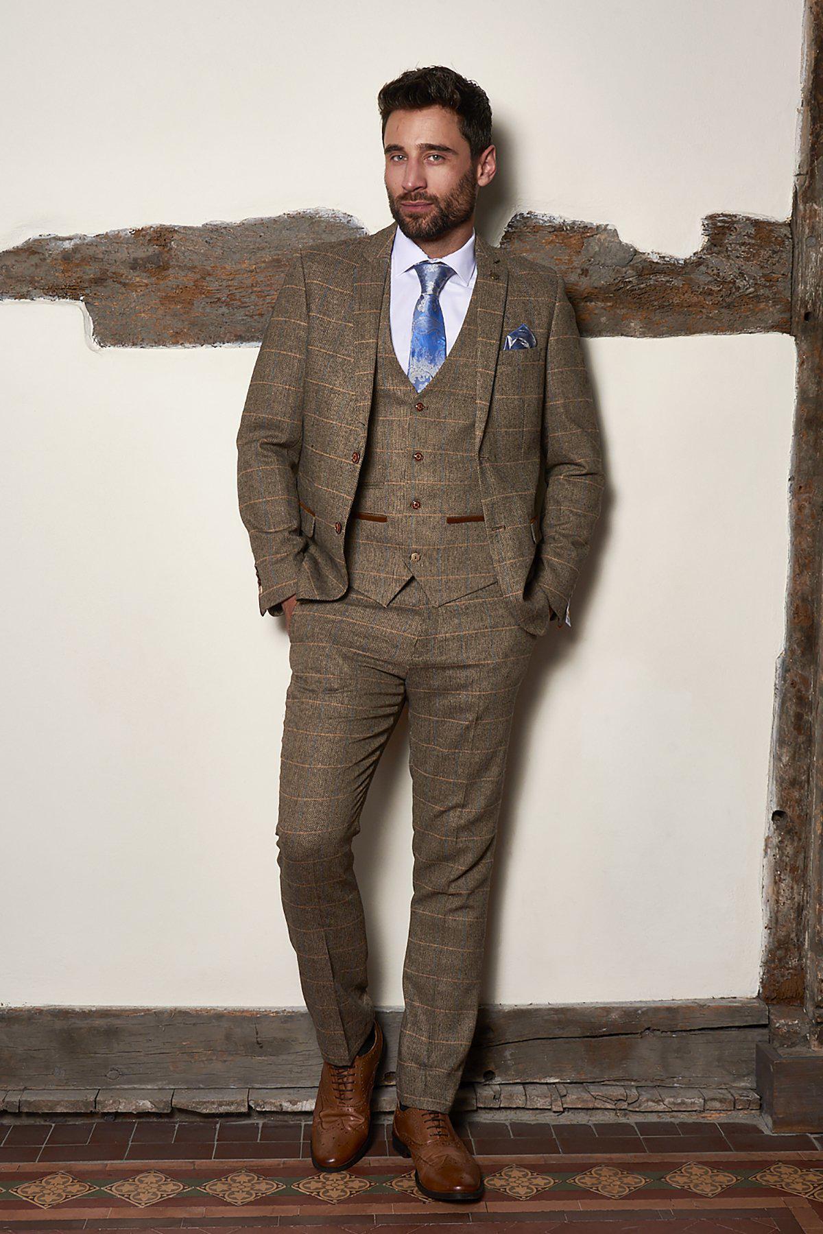 A man showcases the marcdarcy Matching Father & Son Men’s TED Tan Tweed Check Three Piece Suit, offering perfect inspiration for a country barn wedding look.