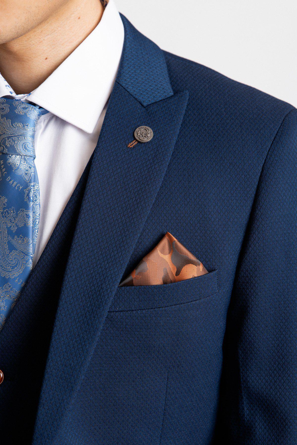 A close-up of a person wearing the marcdarcy MAX - Royal Blue Blazer with TED Waistcoat, paired with a white shirt, blue patterned tie, and orange pocket square. Only the lower face, neck, and upper torso are visible for a smart-casual style.