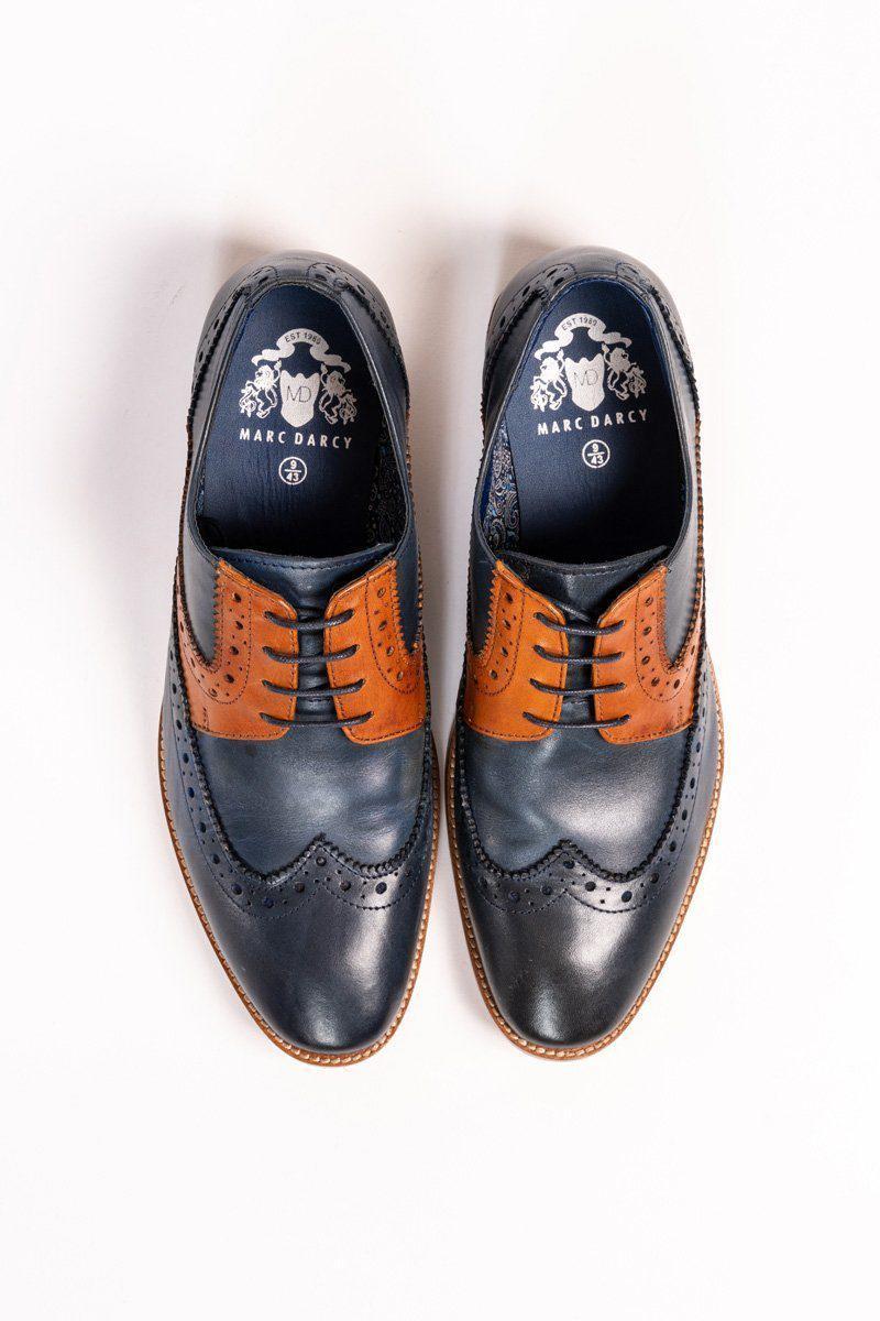 A pair of Marc Darcy RILEY navy and tan leather contrast Oxford brogue shoes, featuring decorative perforations and branded black insoles, arranged side by side on a white background.