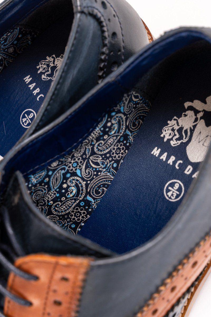 Close-up of the inside of two RILEY - Navy Tan Leather Contrast Oxford Brogue Shoes, featuring a blue paisley-patterned insole and “Marc Darcy” with size 9 (43) printed in white.