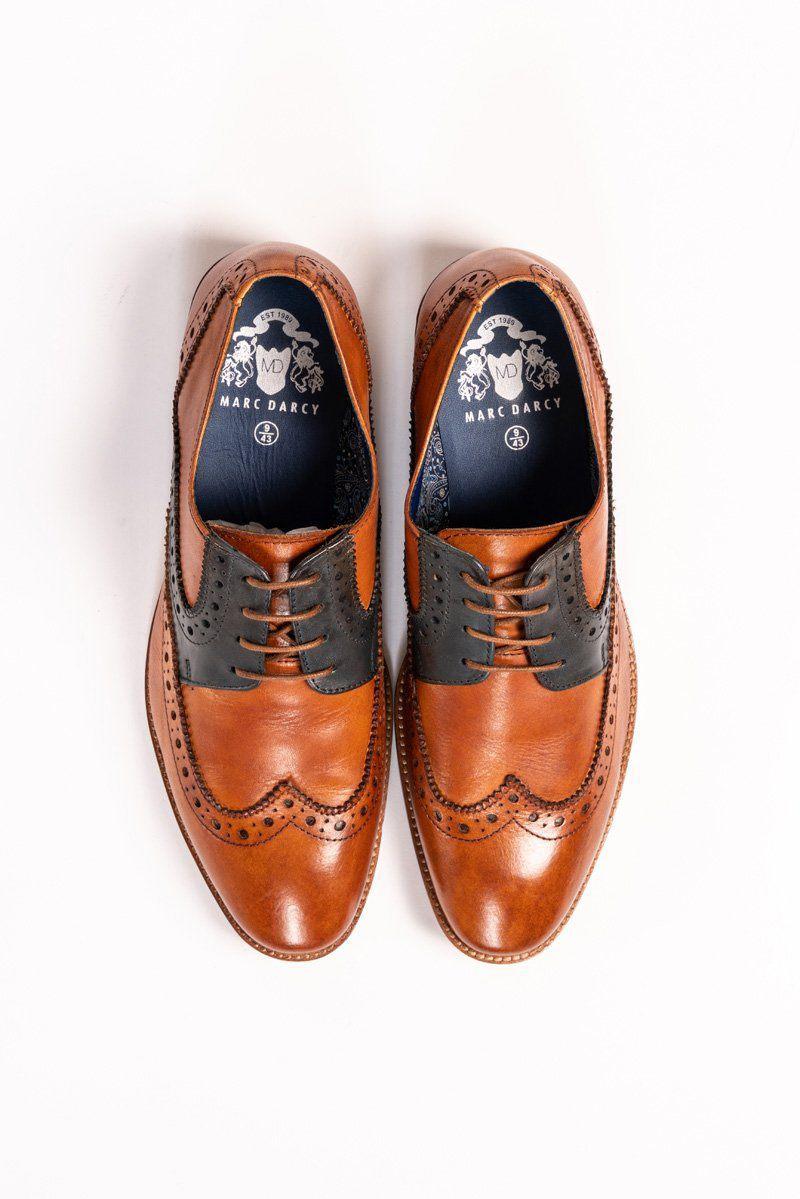 A pair of RILEY - Tan Navy Leather Contrast Oxford Brogue Shoes by Marc Darcy, featuring hand-painted leather and decorative perforations, viewed from above on a white background with visible Marc Darcy logo on the insoles.
