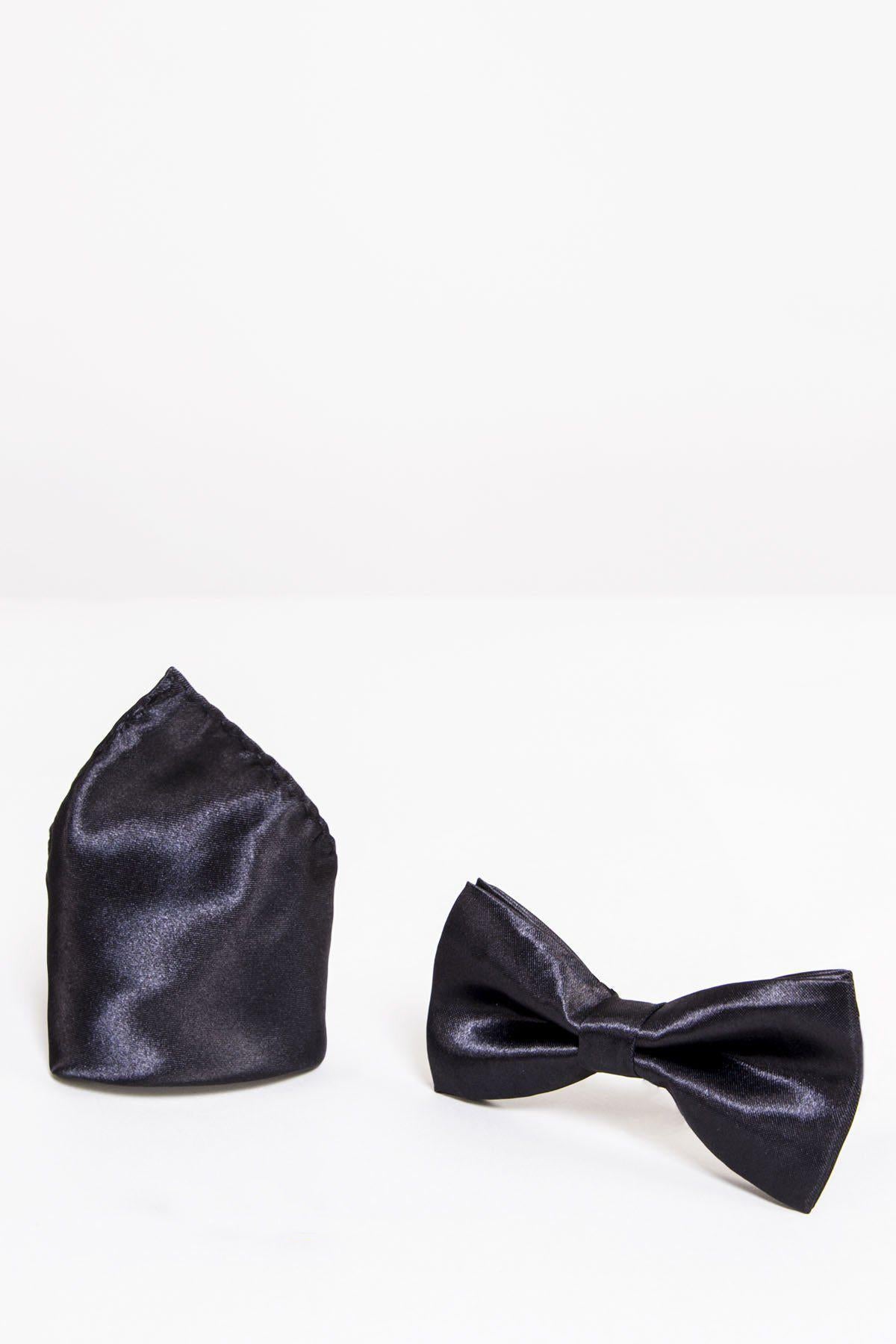 The STANLEY - Satin Bow Tie and Pocket Square Set in Black by Accessory features a shiny pre-tied bow tie and matching pocket square, displayed upright on a white surface—an ideal choice for formal wear.