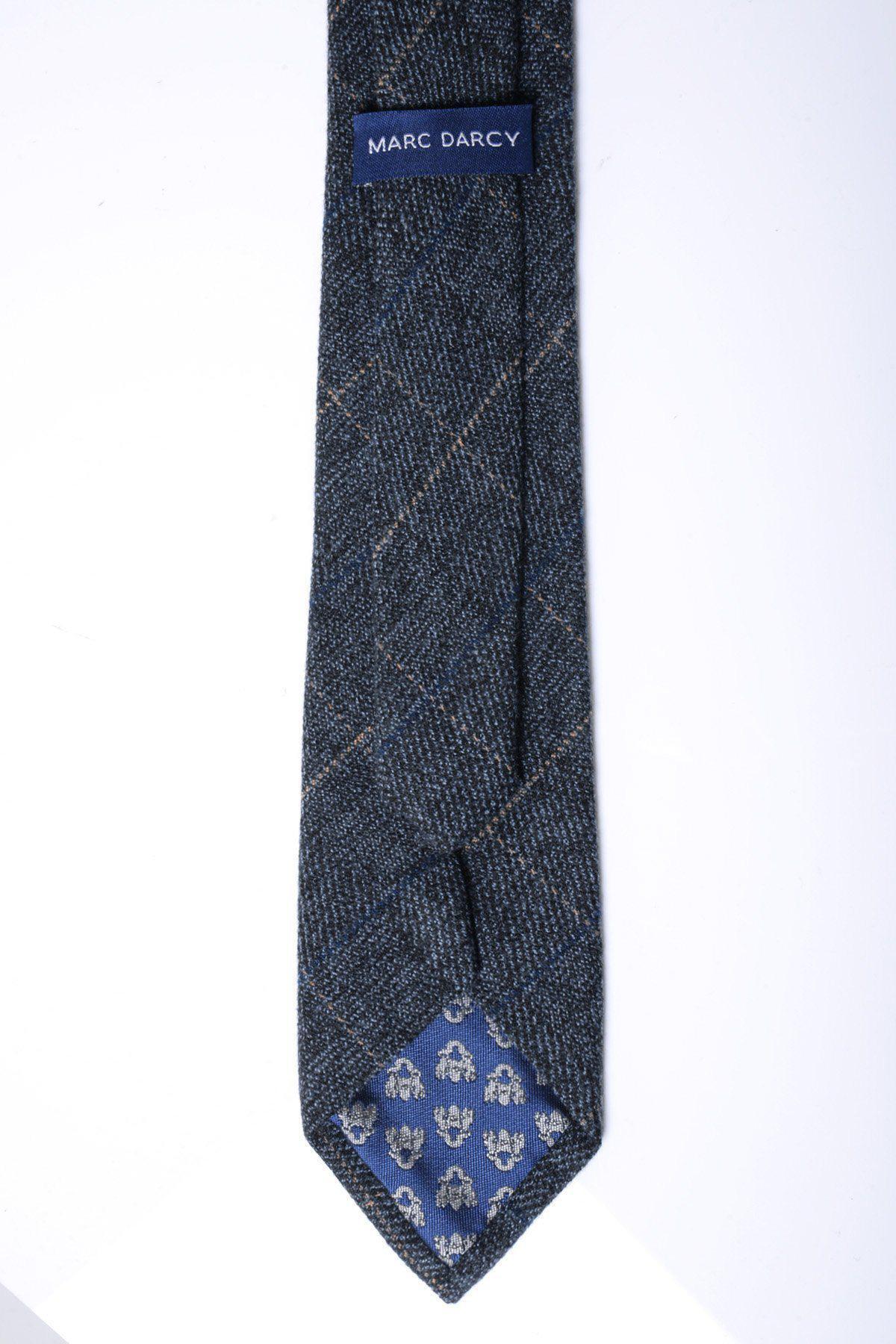 A close-up of the SCOTT - Blue Tweed Check Tie by Accessory shows its plaid texture and visible blue floral inner lining—ideal for enhancing your formal look.