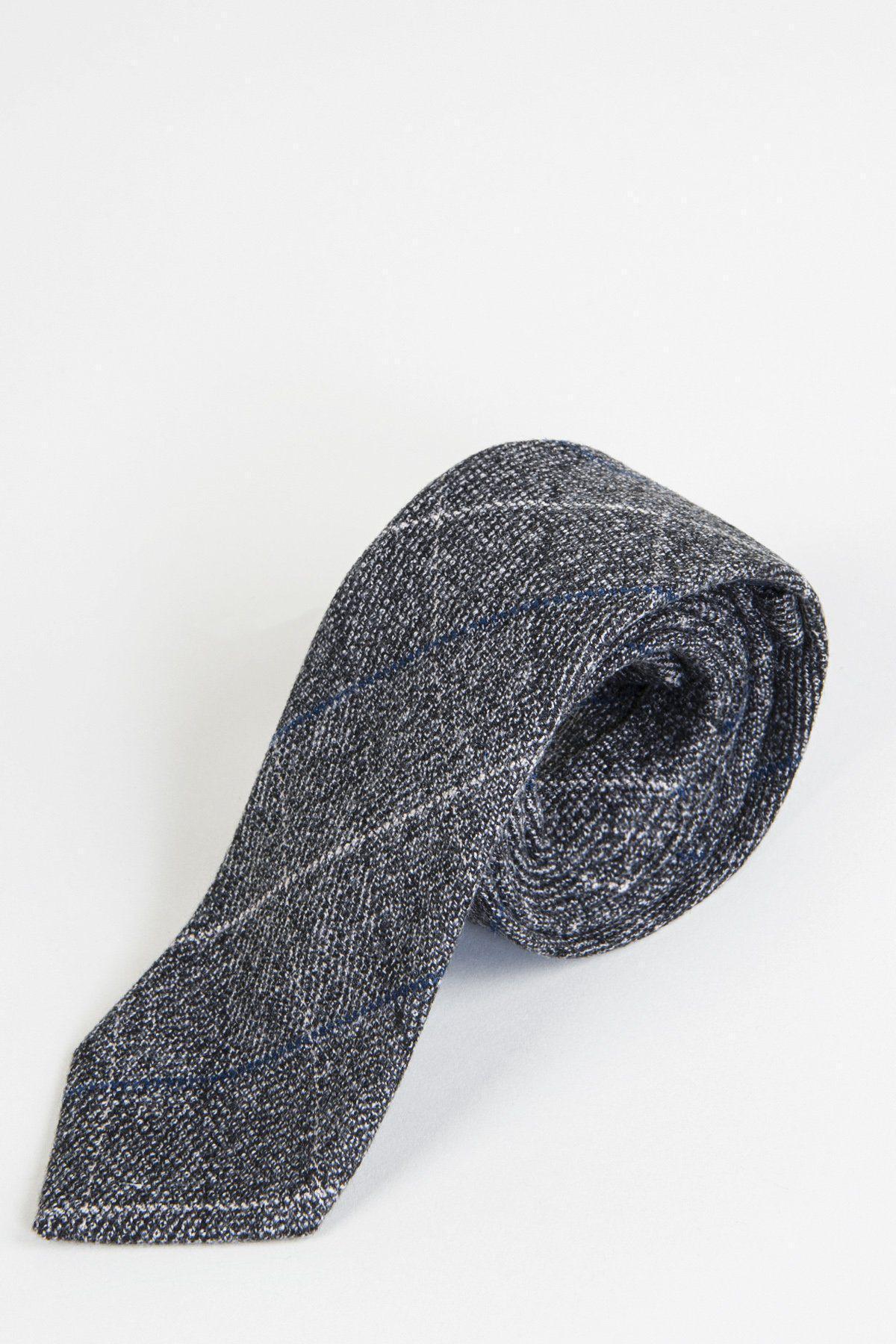 The SCOTT - Grey Tweed Check Tie by Accessory, featuring a gray and blue check pattern, is rolled up and displayed on a white background—ideal for formalwear.