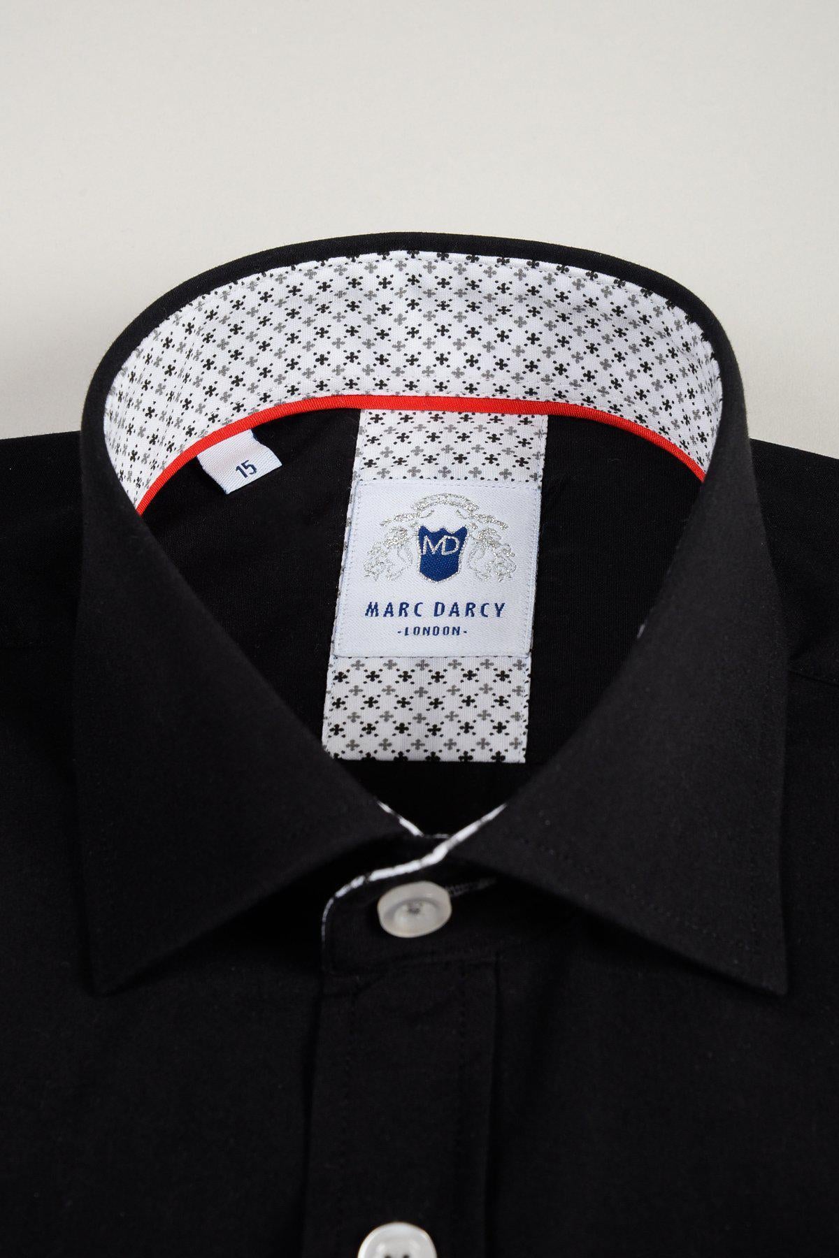 A close-up of the marcdarcy SERGIO black long sleeve shirt, classic fit with white buttons, patterned inner collar, and “Marc Darcy London” label. Made from a comfortable cotton blend.