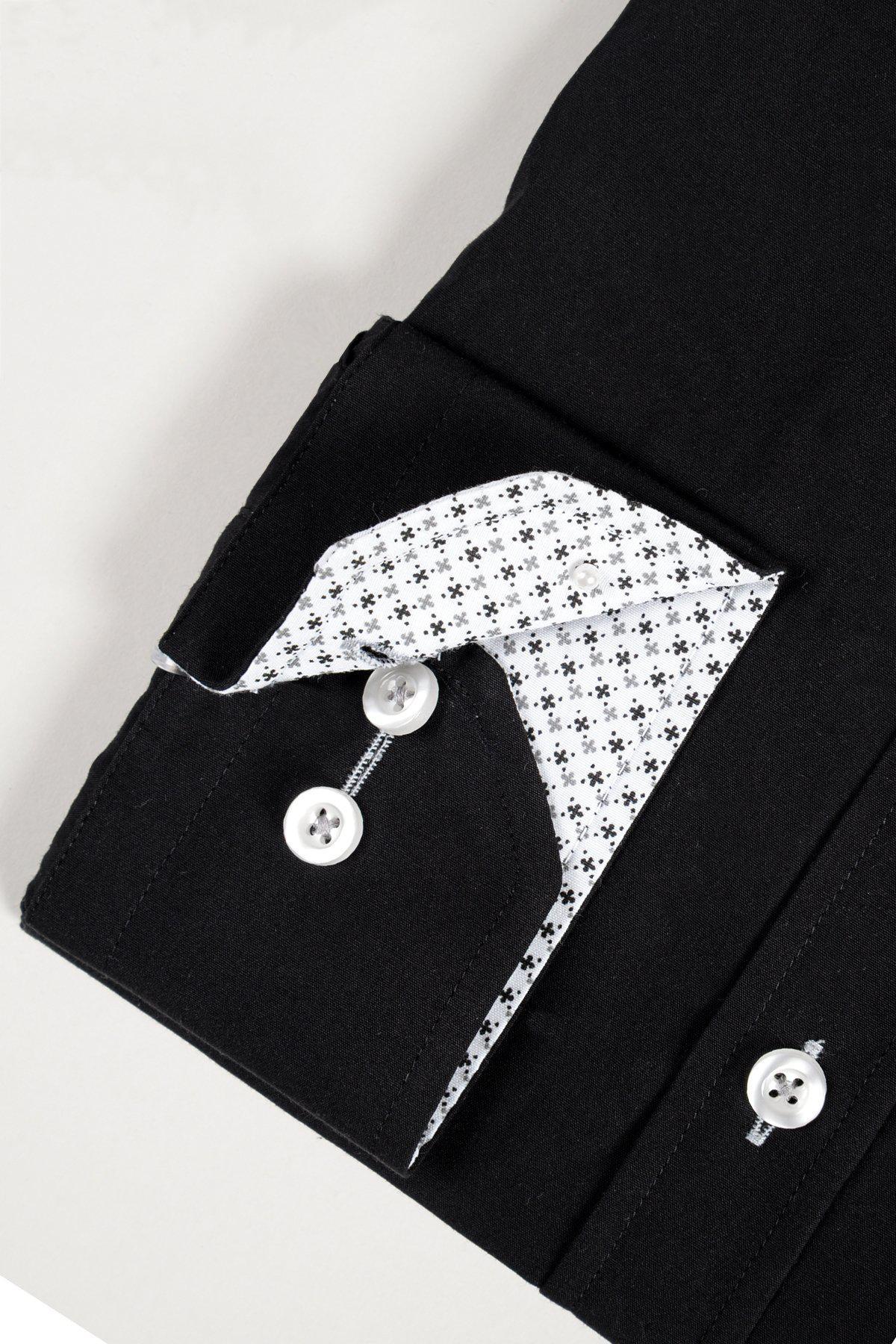 A close-up of the marcdarcy SERGIO black long sleeve shirt cuff in a soft cotton blend, featuring white buttons and a folded-back lining with a small black geometric pattern on white.