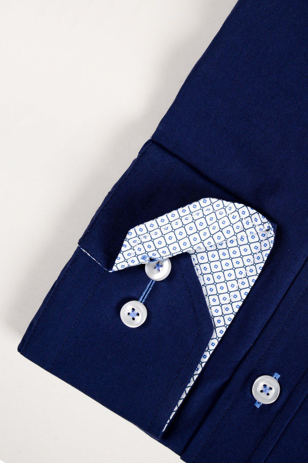 Close-up of the marcdarcy SERGIO navy long sleeve shirt's cuff, featuring white buttons and a white lining with a small blue geometric pattern. The classic fit shirt is neatly folded on a light background.