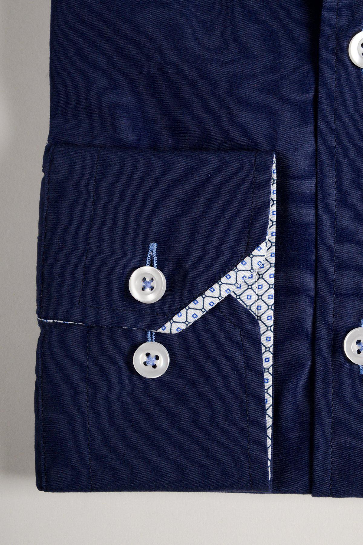 A close-up of the marcdarcy SERGIO Navy Long Sleeve Shirt cuff with white buttons and a small pocket. The inner lining shows a white fabric accented by a geometric blue pattern along the edge and seam.