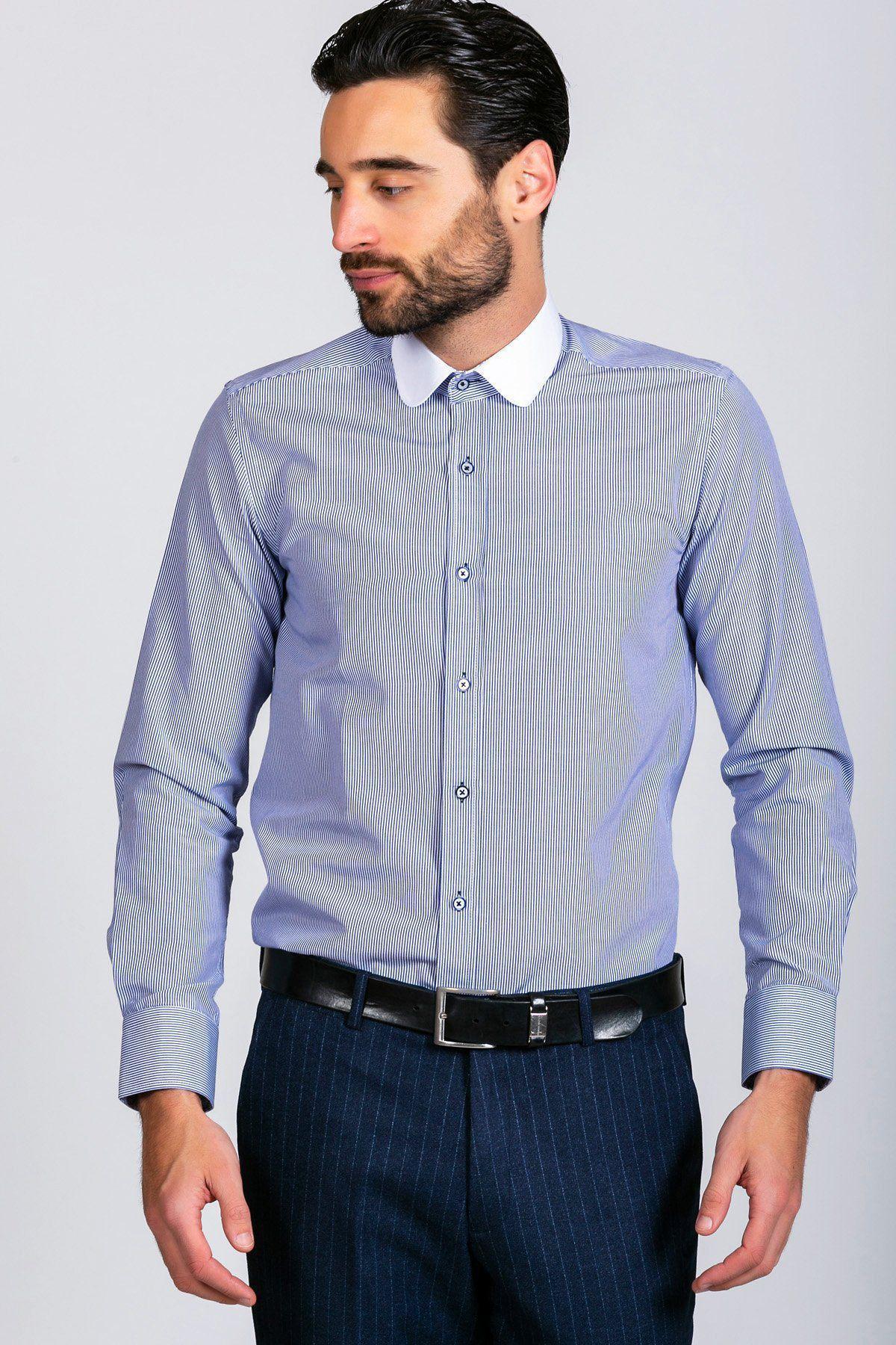 A style-conscious man with dark hair and a beard wears the Marc Darcy SHELBY - Navy Blue Stripe Penny Collar Shirt, navy pinstriped pants, and a black belt. He looks to the side, set against a plain background.