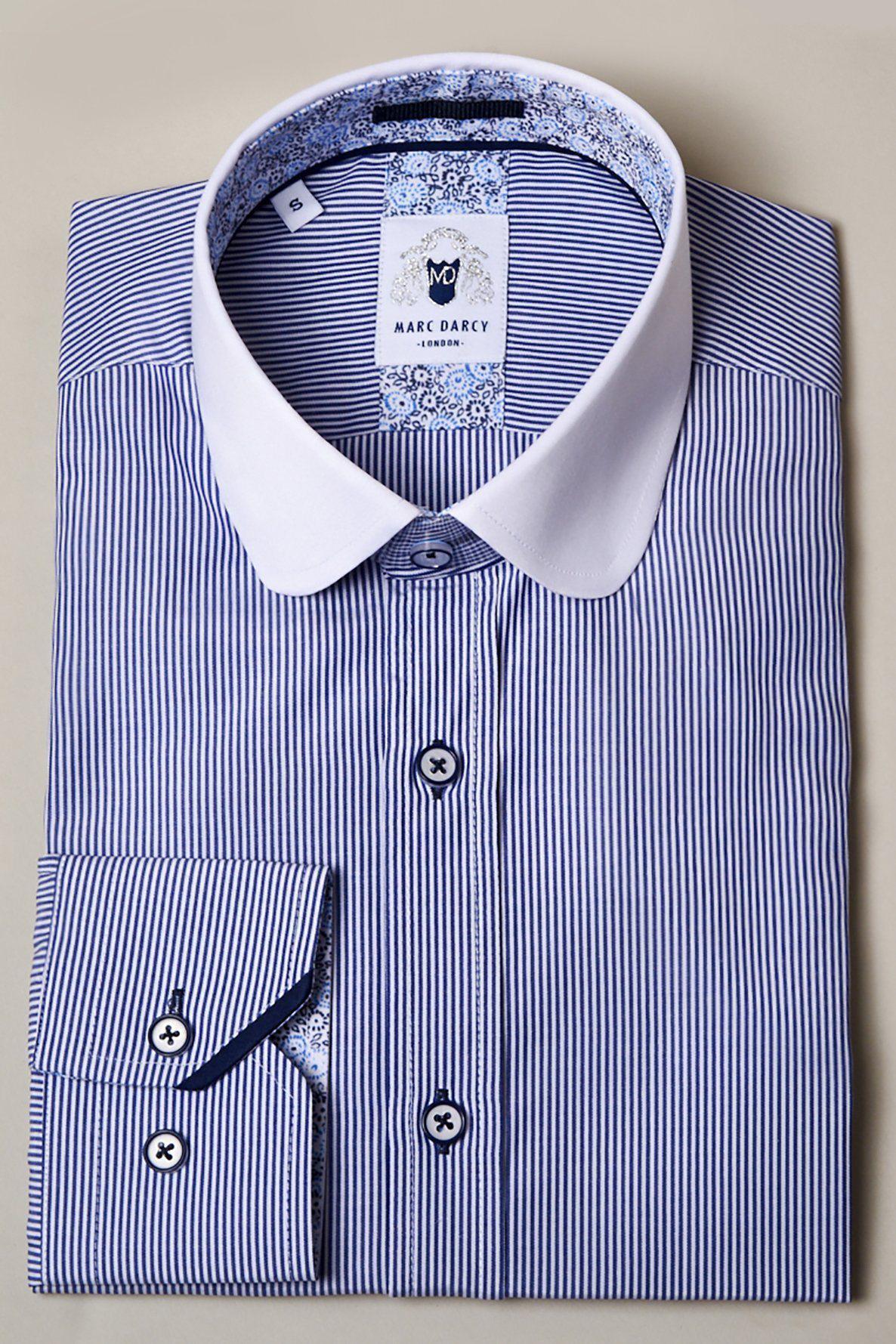 The SHELBY Navy Blue Stripe Penny Collar Shirt by Marc Darcy features classic blue and white stripes, a white collar, buttoned cuffs, and timeless Tommy Shelby-inspired style.