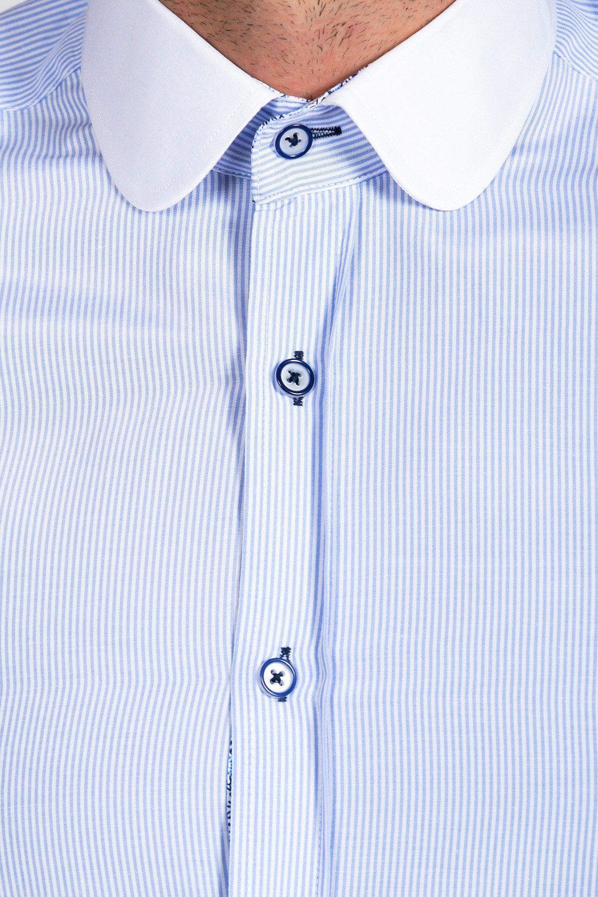 Close-up of the Marc Darcy SHELBY Sky Blue Stripe Penny Collar Shirt, featuring white pin stripes, a white rounded collar, blue-trimmed buttons, and high cotton content. Only the lower face and upper torso of the wearer are shown.