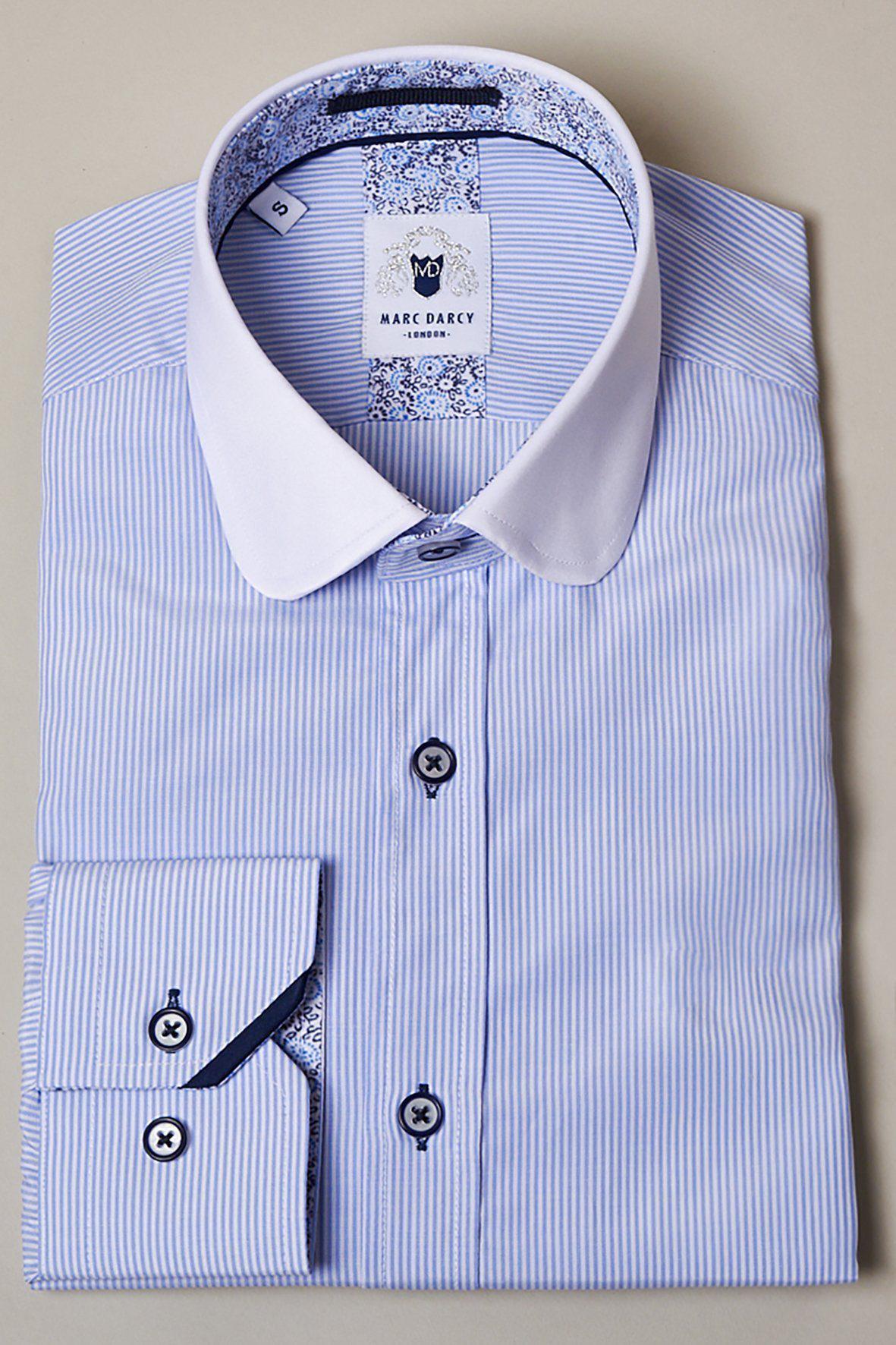 The SHELBY Sky Blue Stripe Penny Collar Shirt by Marc Darcy features white stripes, a white collar, and contrasting dark blue buttons—perfect for achieving that classic Tommy Shelby style.
