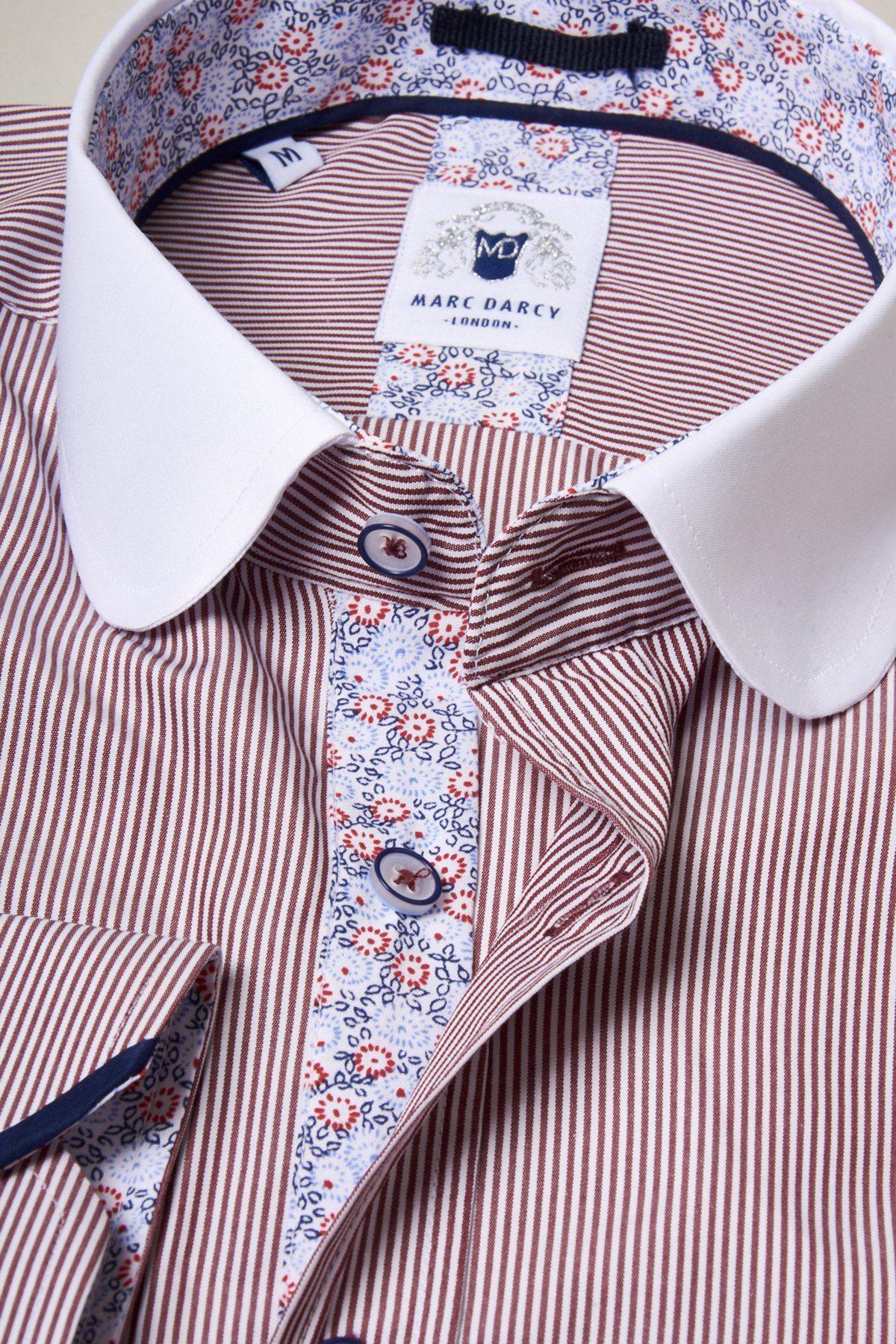 A close-up of the Marc Darcy SHELBY - Wine Stripe Penny Collar Shirt, featuring thin wine stripes, a contrasting white penny collar, and a floral-patterned inner lining around the buttons and collar. The label reads Marc Darcy.