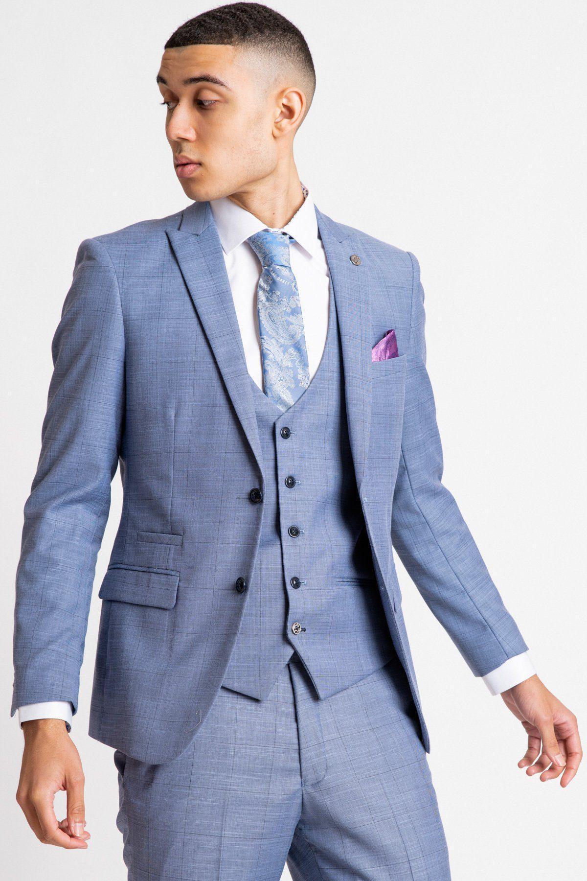 A man wearing the marcdarcy SID - Blue Grey Check Blazer paired with a white shirt, patterned blue tie, and a purple pocket square.