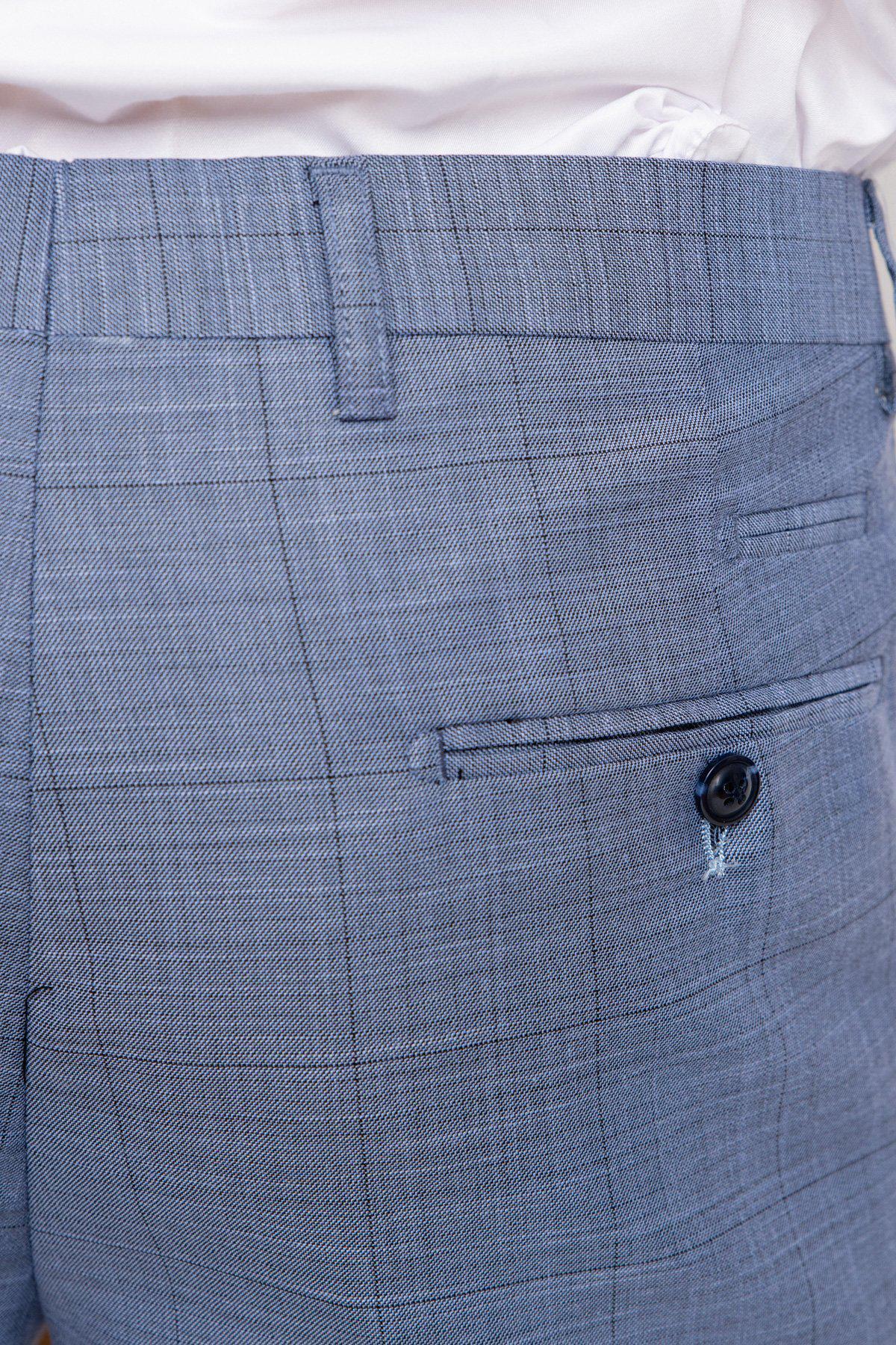 Close-up of a person wearing marcdarcy SID - Blue Grey Check Trousers with a back buttoned pocket, paired with a partially visible tucked-in white shirt.