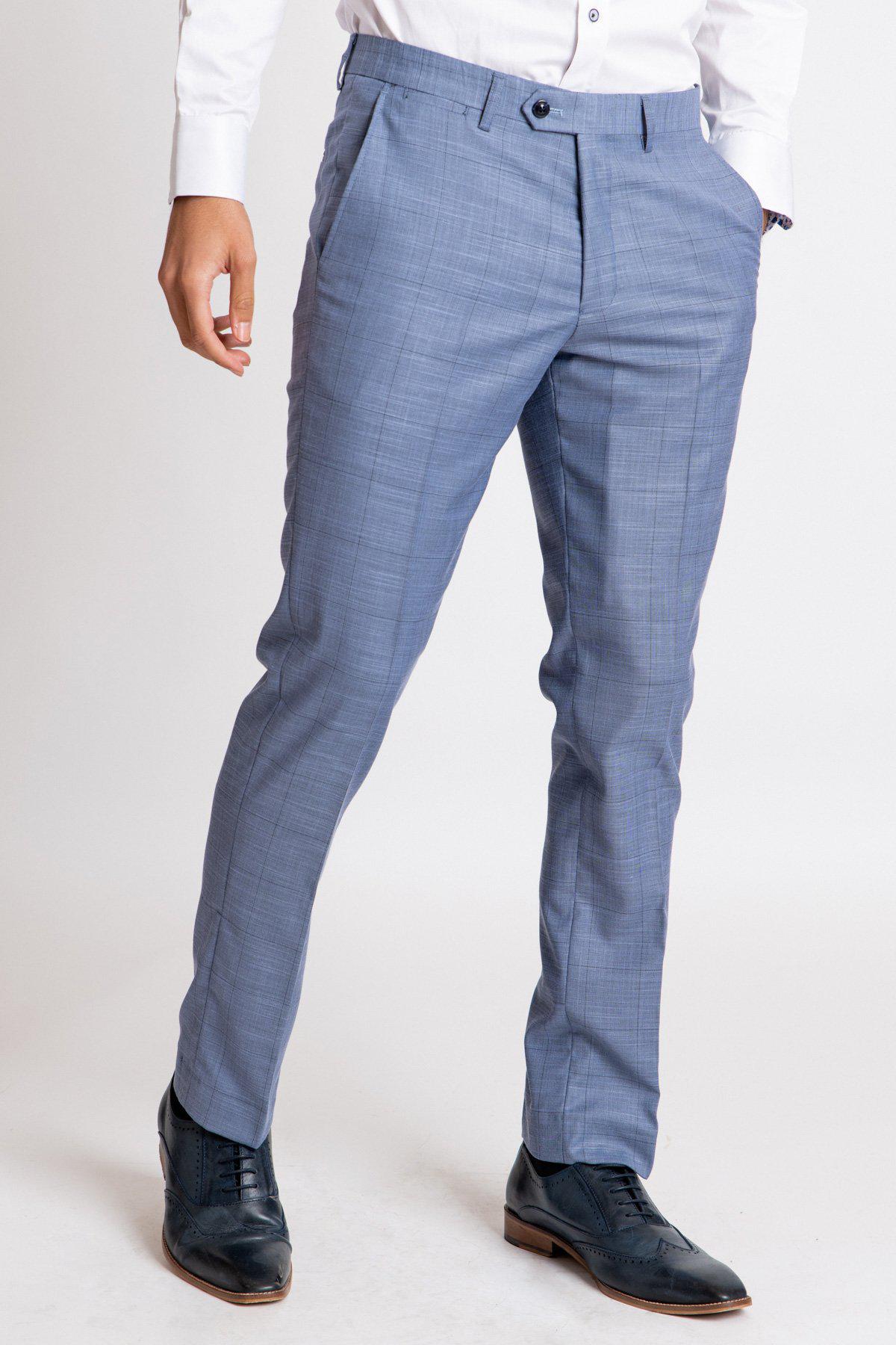 A person wears marcdarcy SID Blue Grey Check Trousers, a white dress shirt, and black dress shoes, standing against a plain white background.