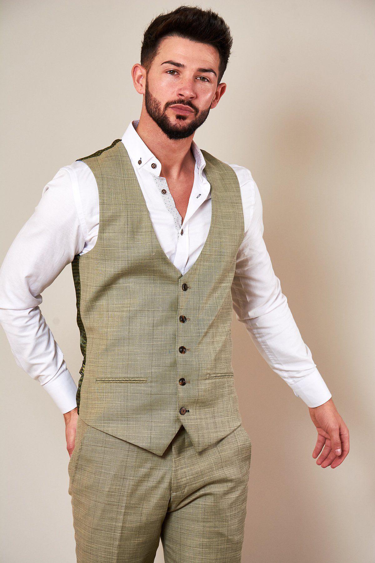 A man with short dark hair and a beard wears the Marc Darcy SID Mustard Beige Check Single Breasted Waistcoat and matching pants over a white button-down shirt, standing against a plain light background.